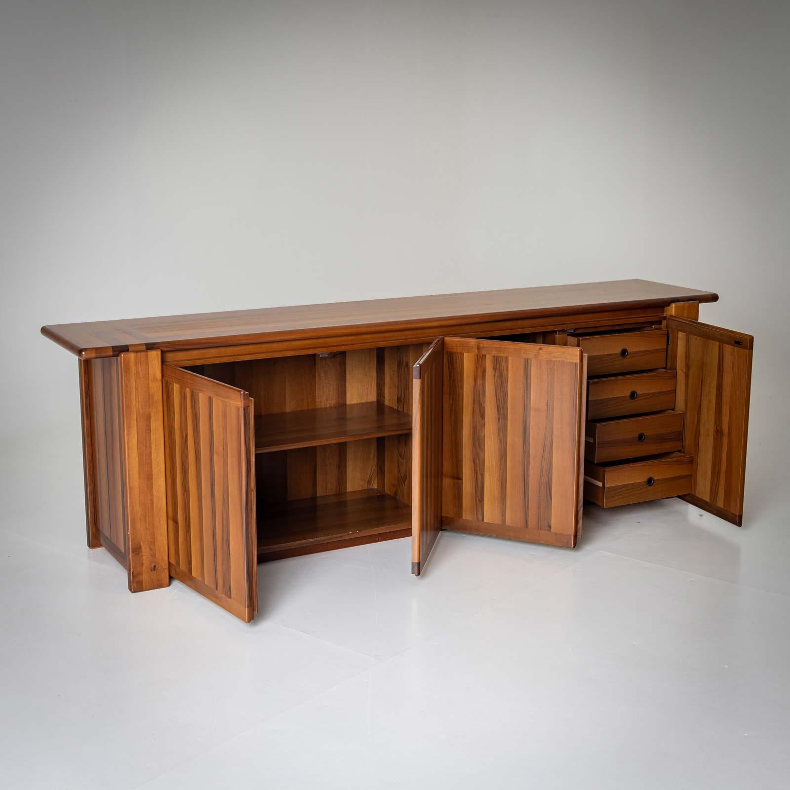 Four-door sideboard designed by Mario Marenco for Mobil Girgi. The sideboard is completely veneered and has a soft, rounded design. The interior division consists of two shelves and four drawers.