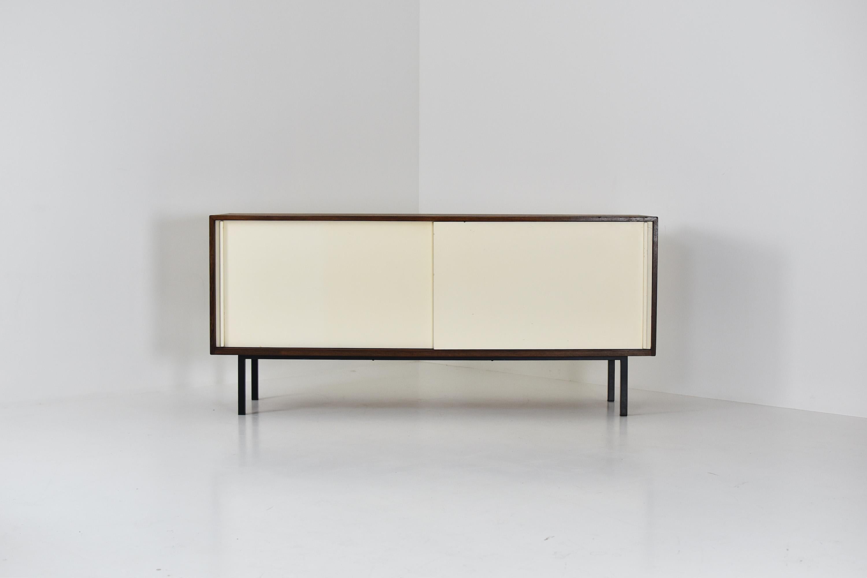 Modernist sideboard designed by Martin Visser and Jos Manders for ‘t Spectrum, The Netherlands, 1958. This is Model No. ‘KW87’ made out of wenge, white painted sliding doors and a black lacquered steel frame. The doors covering a series of three