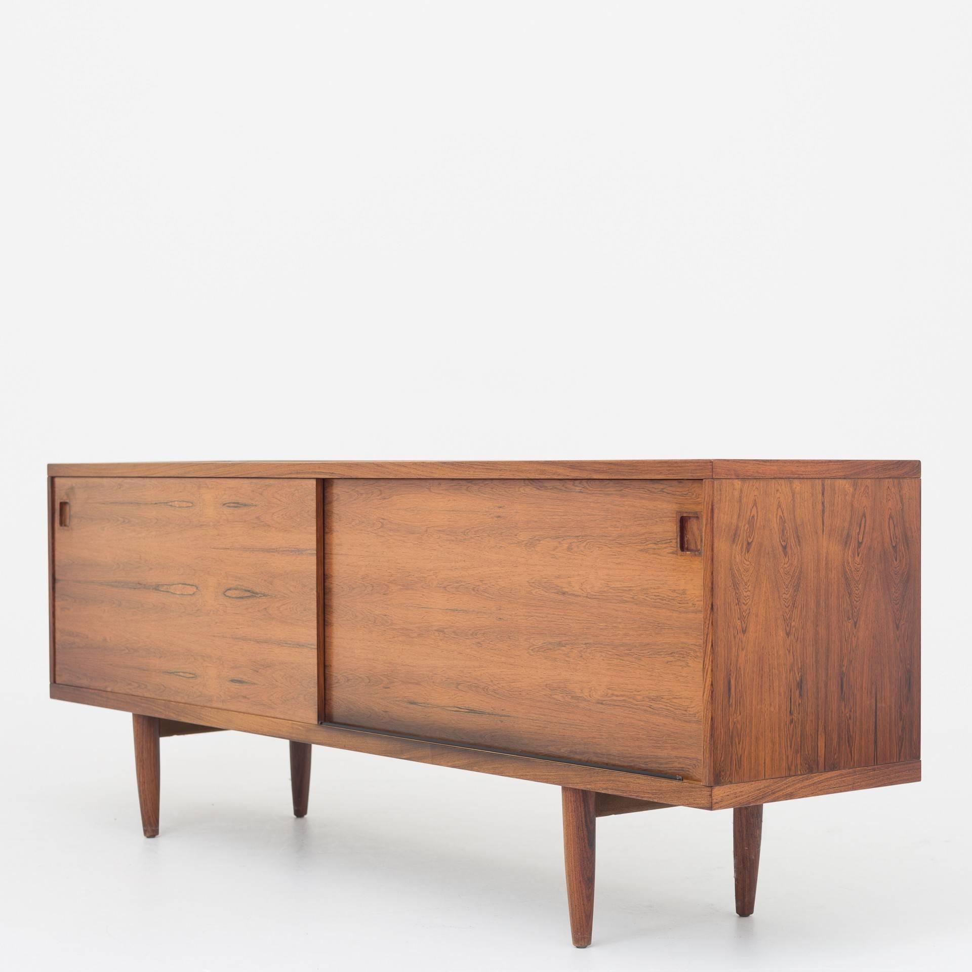 Sideboard in rosewood with two doors and interior. Maker J. L. Møllers møbelfabrik.