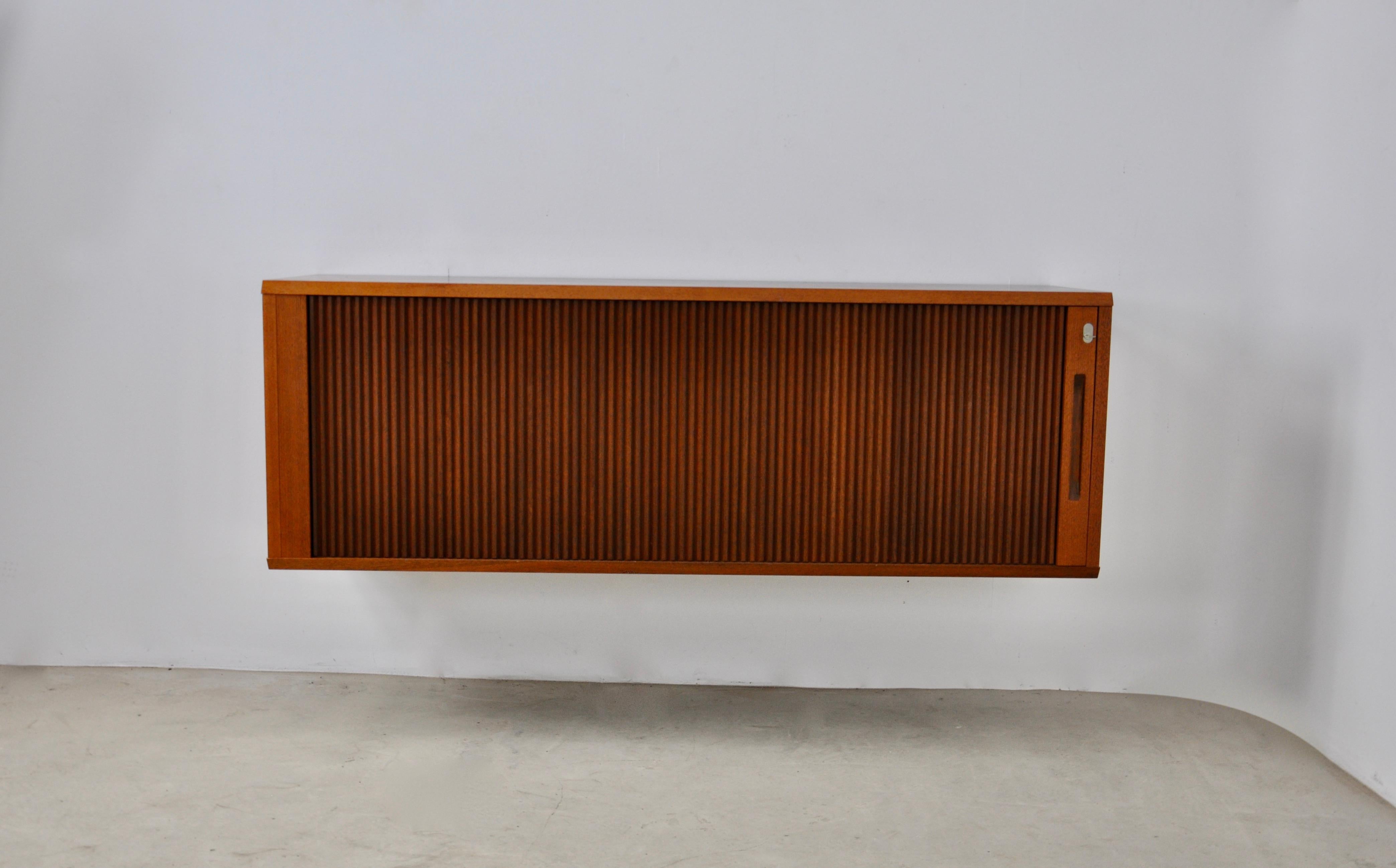 Wooden sideboard to hang on the wall. It is equipped with a sliding door. Wear due to time and age of the sideboard. Stamped on the back.

 