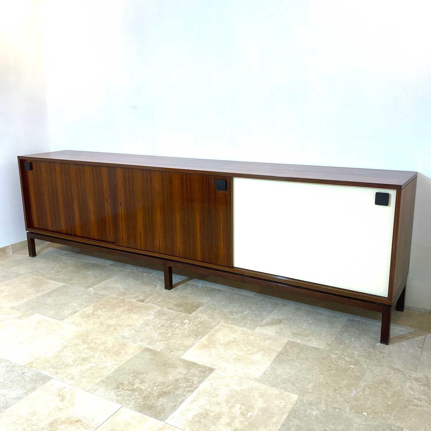 Wonderfull  sideboard by Tito Agnoli for La Linea furniture Italy. Three sliding doors, one row of drawers. Perfect used condition
A series of drawers complete the interior of the piece of furniture like a real silver cabinet. 
Possibility of moving