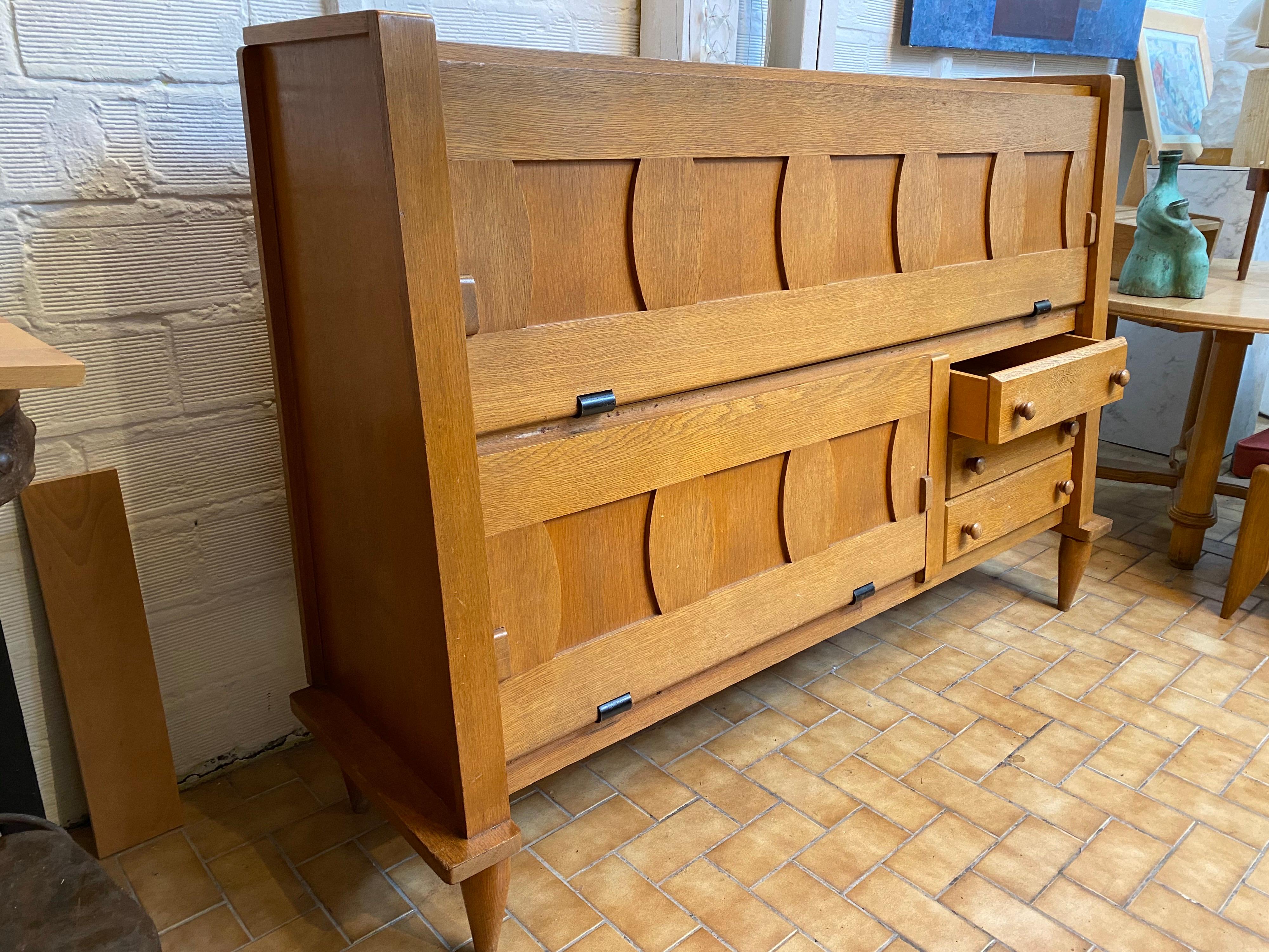 An oak sideboard together could be used as a desk, circa 1960.