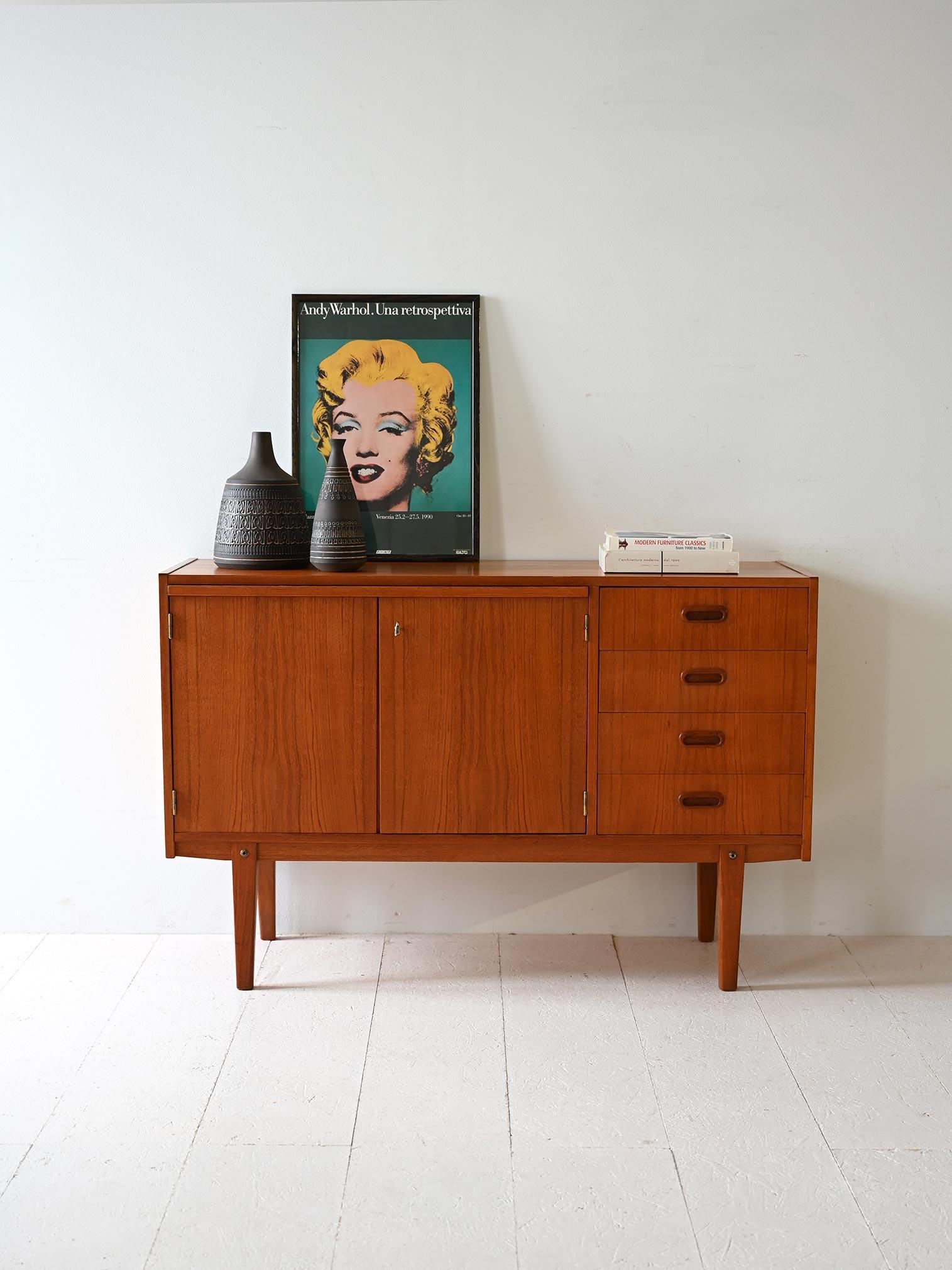 Scandinavian teak cabinet with drawers and hinged doors. The presence of the extaible top turns it into a small writing desk. 

An original vintage furniture piece suitable for different needs. It can also be used as an additional workstation for