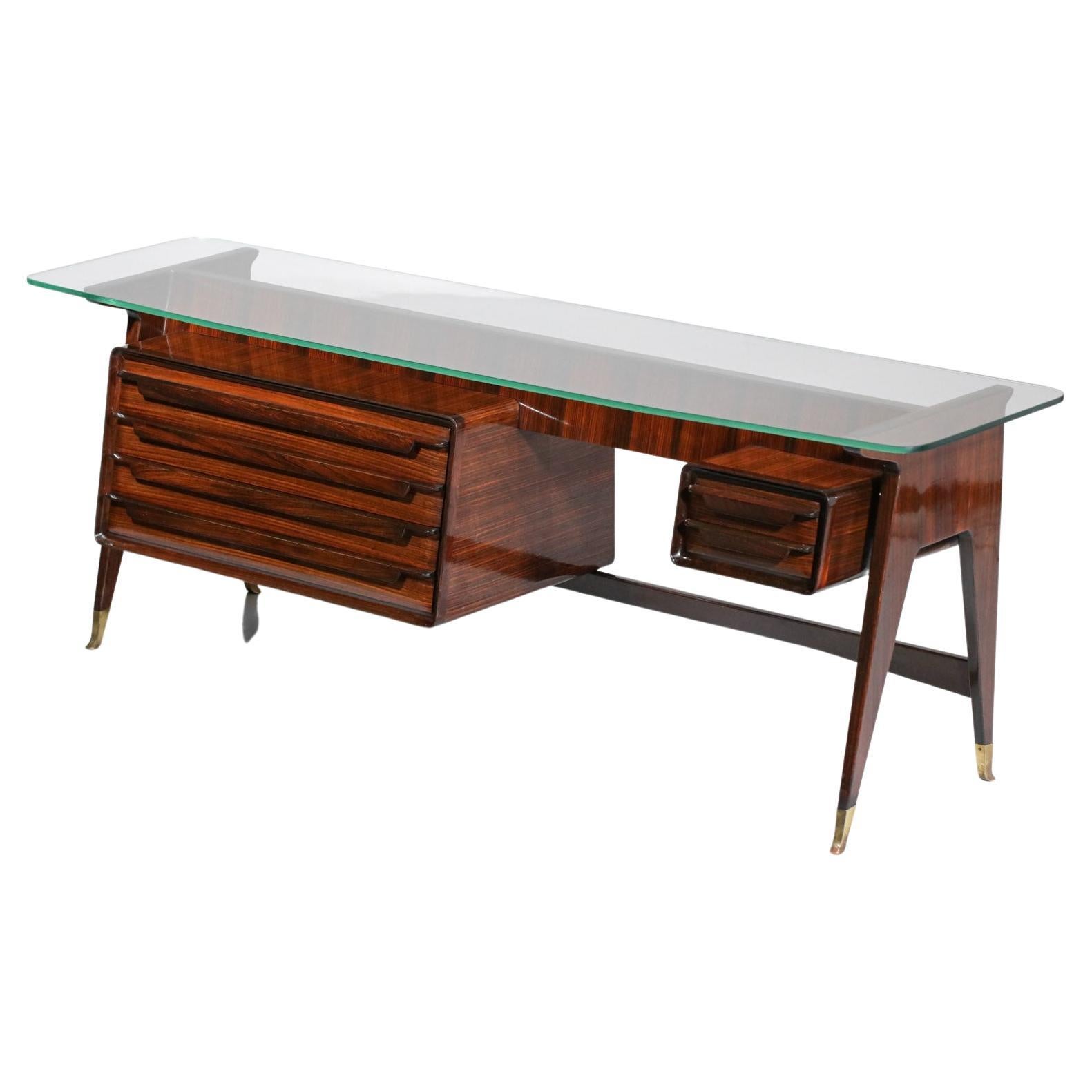 Italian sideboard or console from the 60's by the designer Vittorio Dassi. Structure in veneered and solid wood, top in 1.2 cm thick glass slab. This enfilade is composed of six drawers on each side of the piece of furniture, the legs are finished