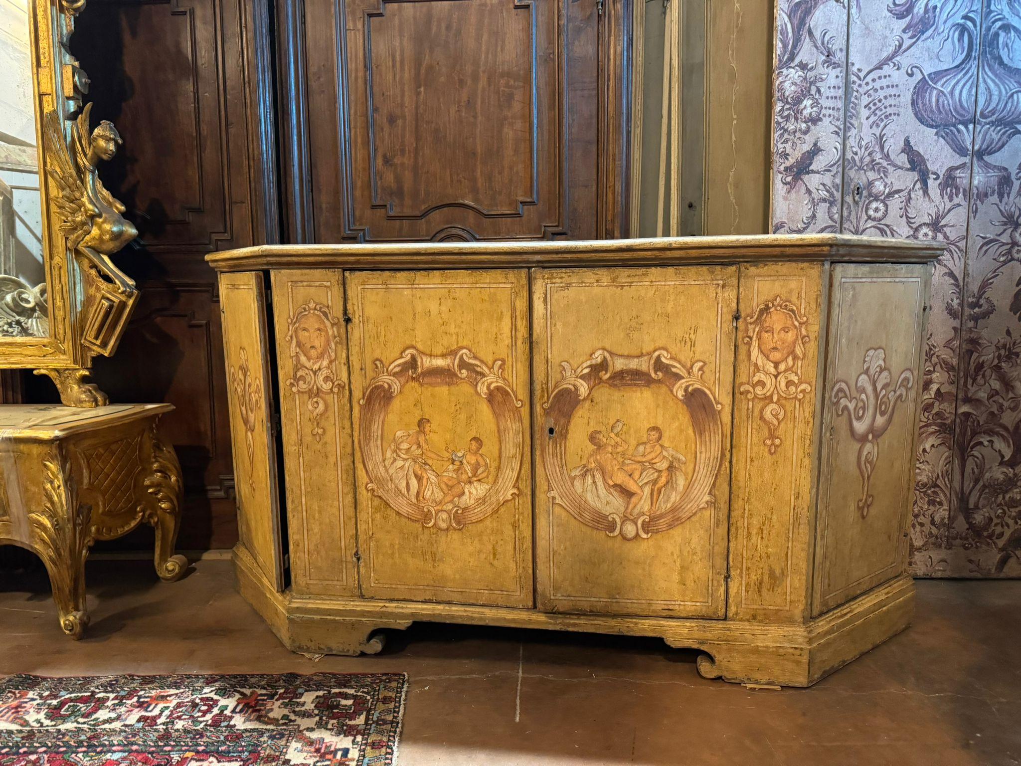 Ancient Credenza, lacquered wooden sideboard painted with figures of bambocci and baroque decorations, It has four doors with large capacity internal shelves, ideal in a prestigious room or in a contrasting modern interior. Original from the 18th