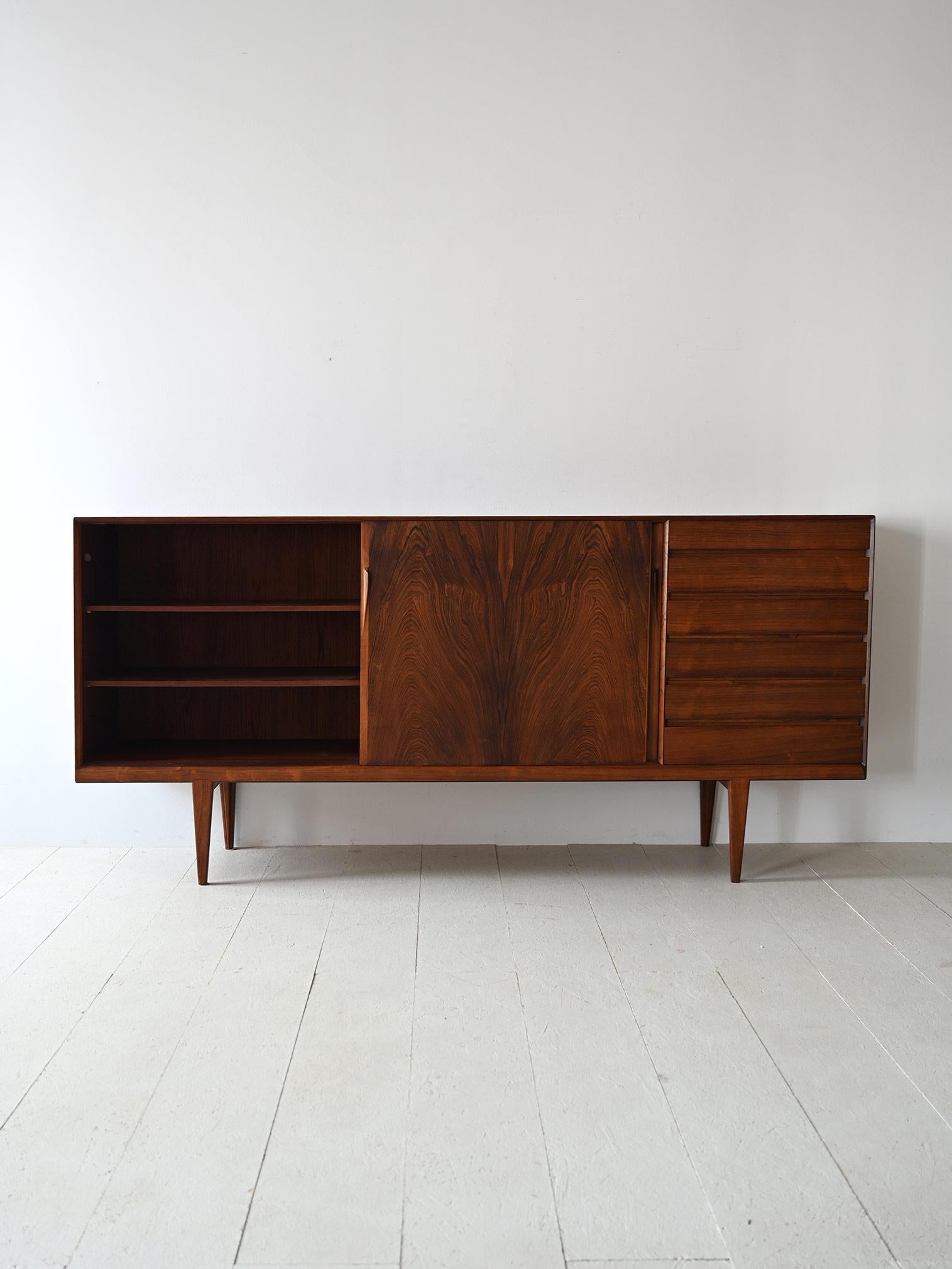 Elegant original Danish sideboard from the 1960s made of rosewood.
The refined and carefully detailed construction of this piece of furniture embodies the spirit of Nordic modernism, offering a blend of style, functionality, and impeccable