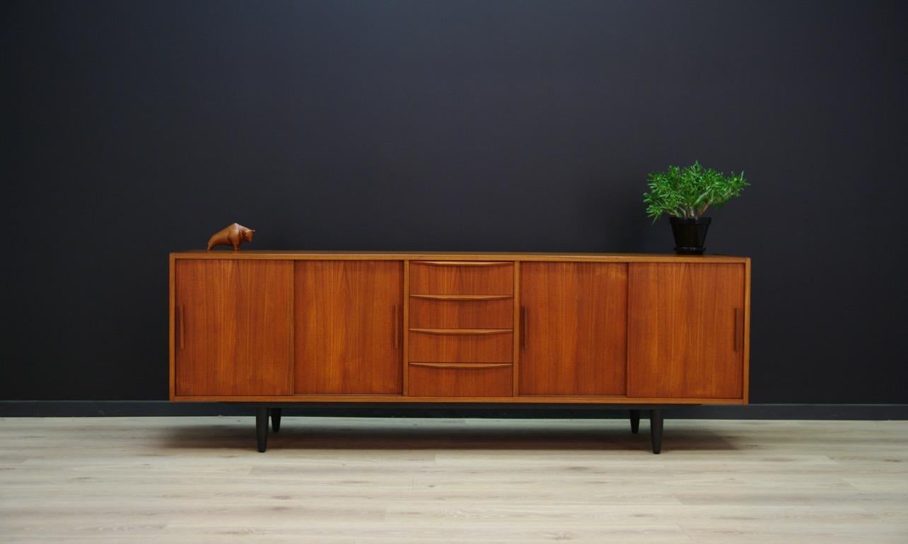 Unique 1960s-1970s sideboard - Minimalistic form - Danish design. The whole is covered with teak veneer. Item has four external drawers, and shelves behind the sliding doors. Preserved in good condition (small bruises and scratches) - directly for