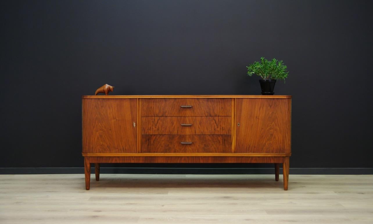 Original sideboard from the 1960s-1970s, Danish design, covered with walnut veneer, has a roomy interior with a shelf and three drawers behind the doors. In addition, three external drawers. The key in the set. Preserved in good condition (minor