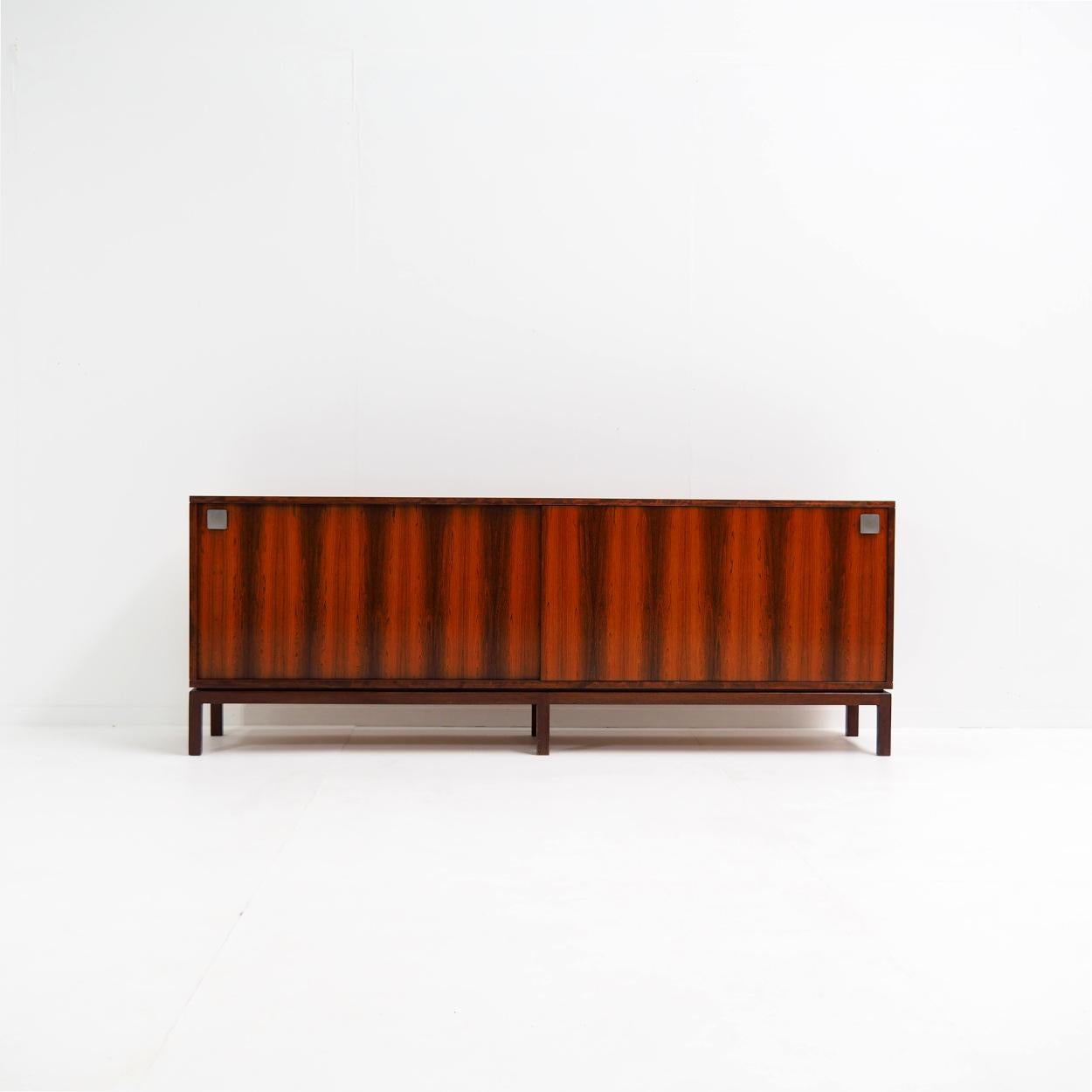 Sideboard designed by the Belgian designer Alfred Hendrickx for Belform.

The sideboard may seem simple at first sight, but it has very clean lines creating a beautiful and perfect symmetrical composition. Pay particular attention to the shape and