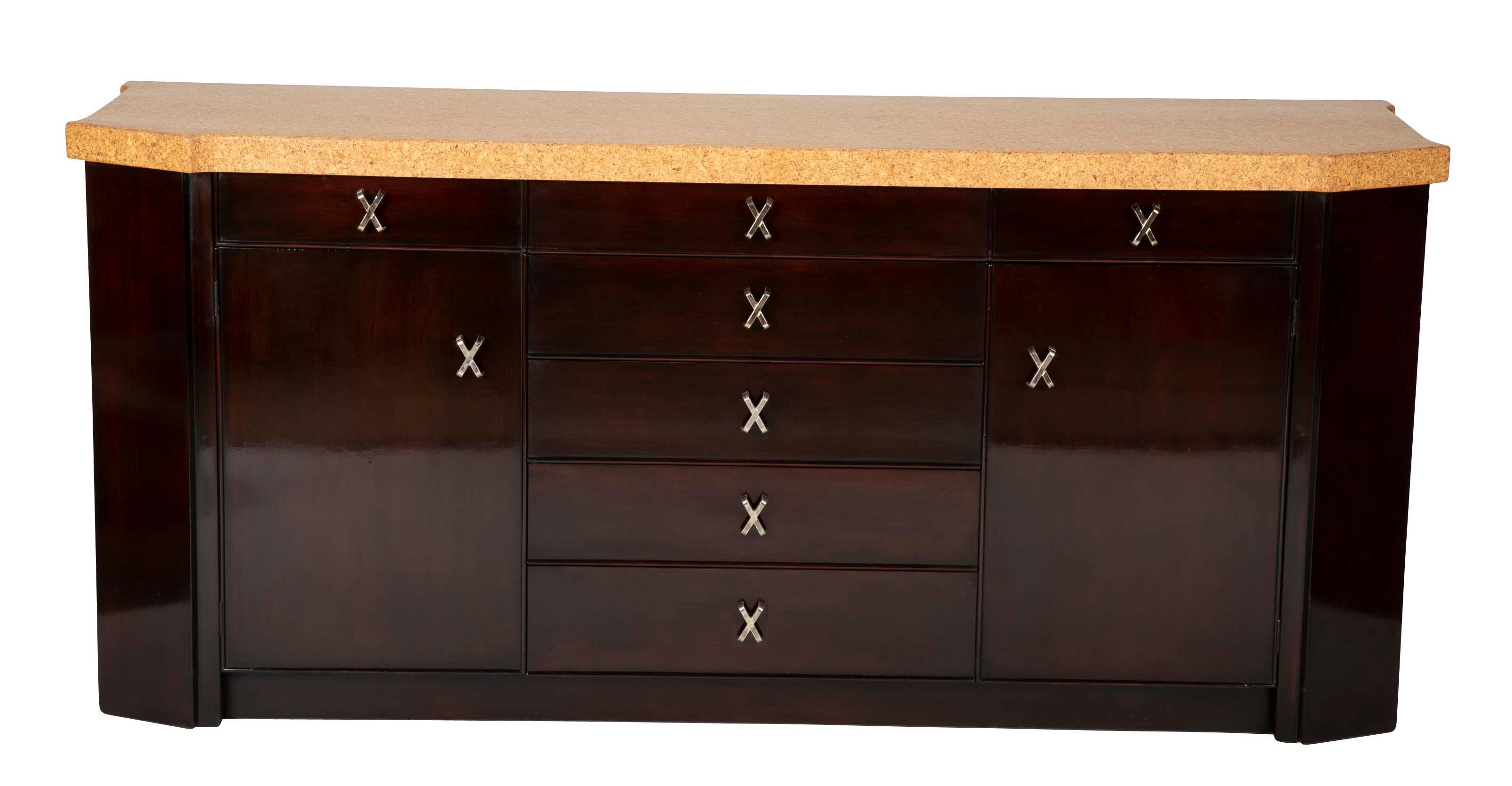 A credenza designed by Paul T. Frankl for Johnson furniture. Mahogany with cork top and gilt X pulls.