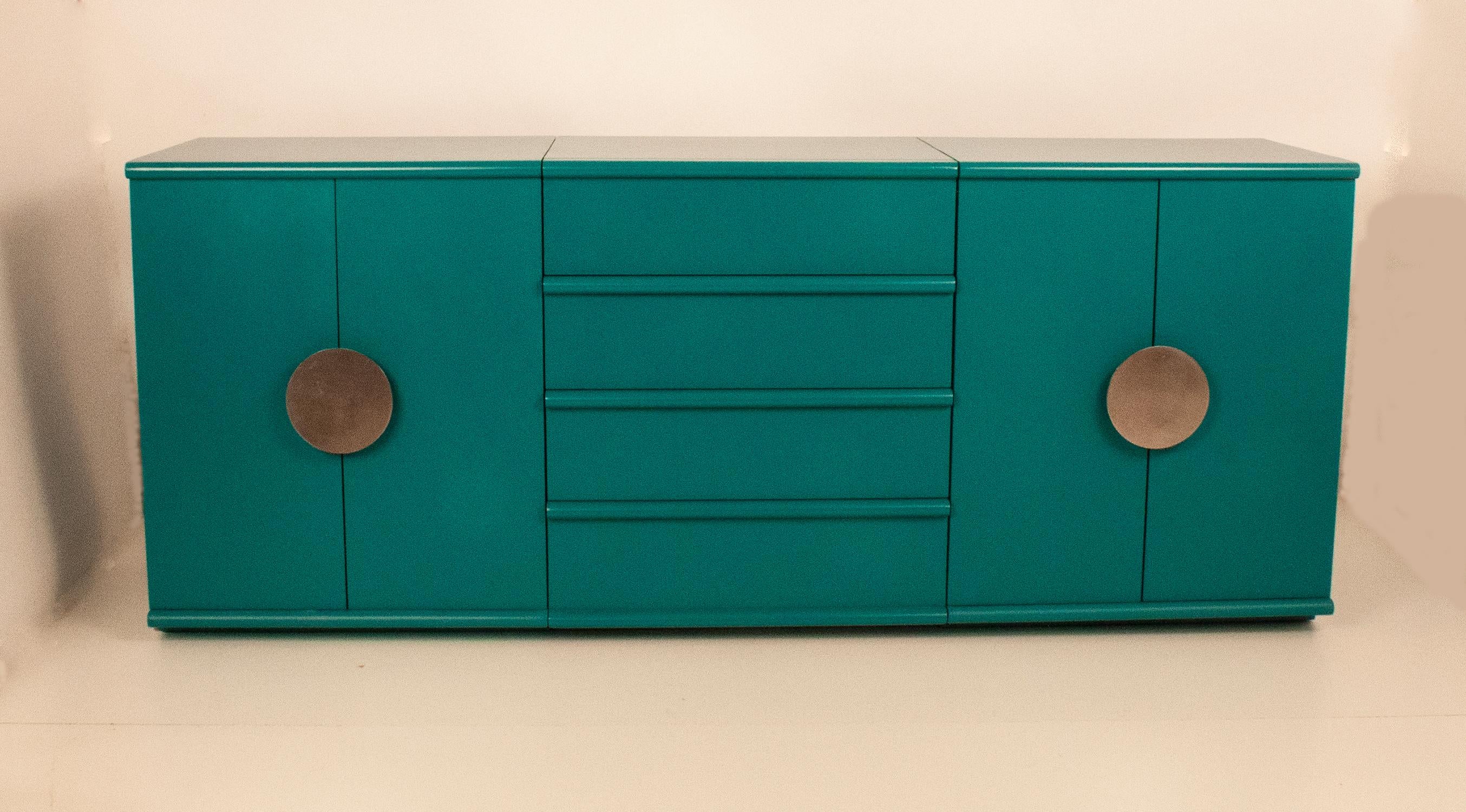 Sideboard designed in 1970's by Jordi Vilanova.
It was originally made of wood and is now lacquered in blue.
It consists of three modules, two of them with hinged doors and a shelf inside and another central module with four drawers.
Two circular