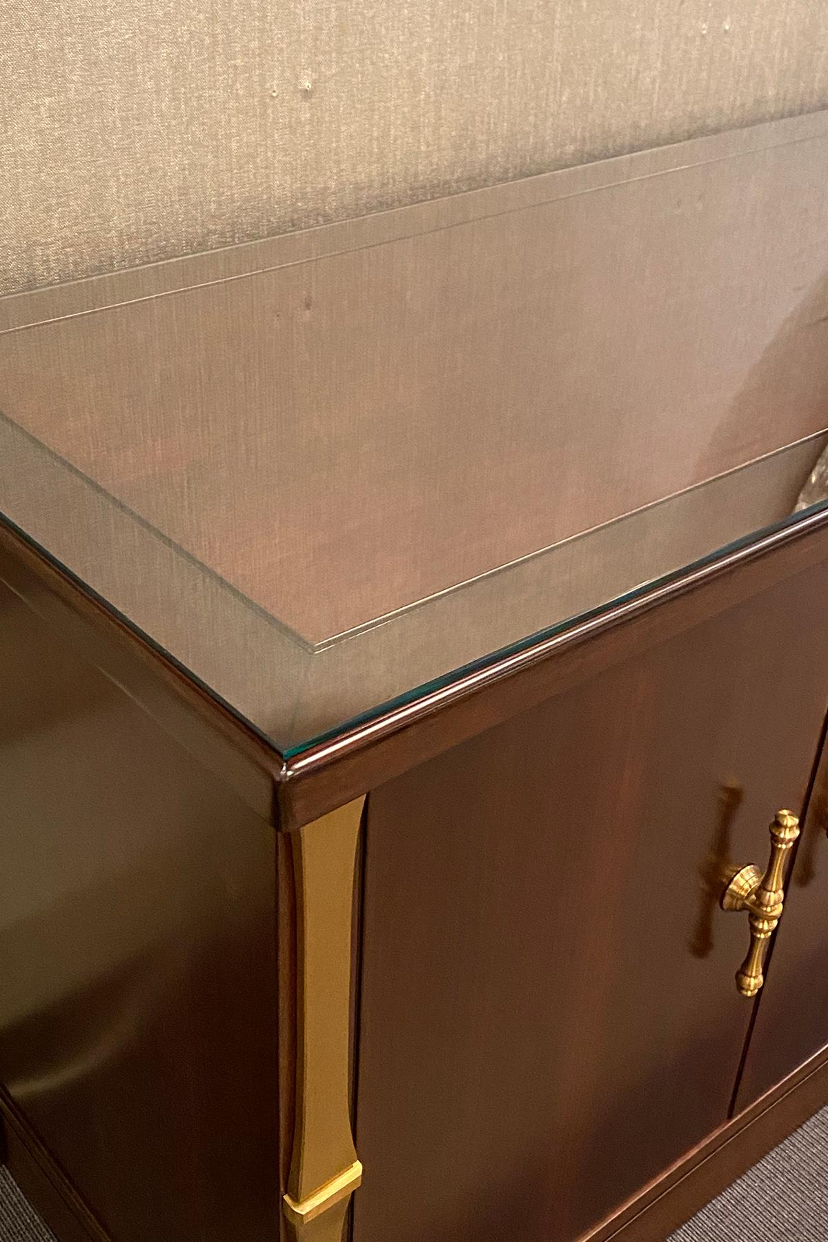 Sideboard
Frigerio, Italy, 1970s

Mahogany body with brass decorations and handles, the interior fitted with four cutlery drawers on the left and a shelf on the right.