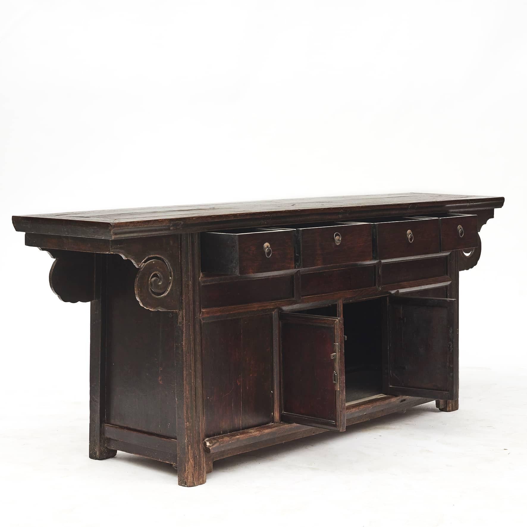Sideboard, Qing style from the late 18th century.
Elm wood with burgundy lacquer, natural age-related patina and wear.
4 Drawers and a pair of doors.

Original condition, lovingly restored.