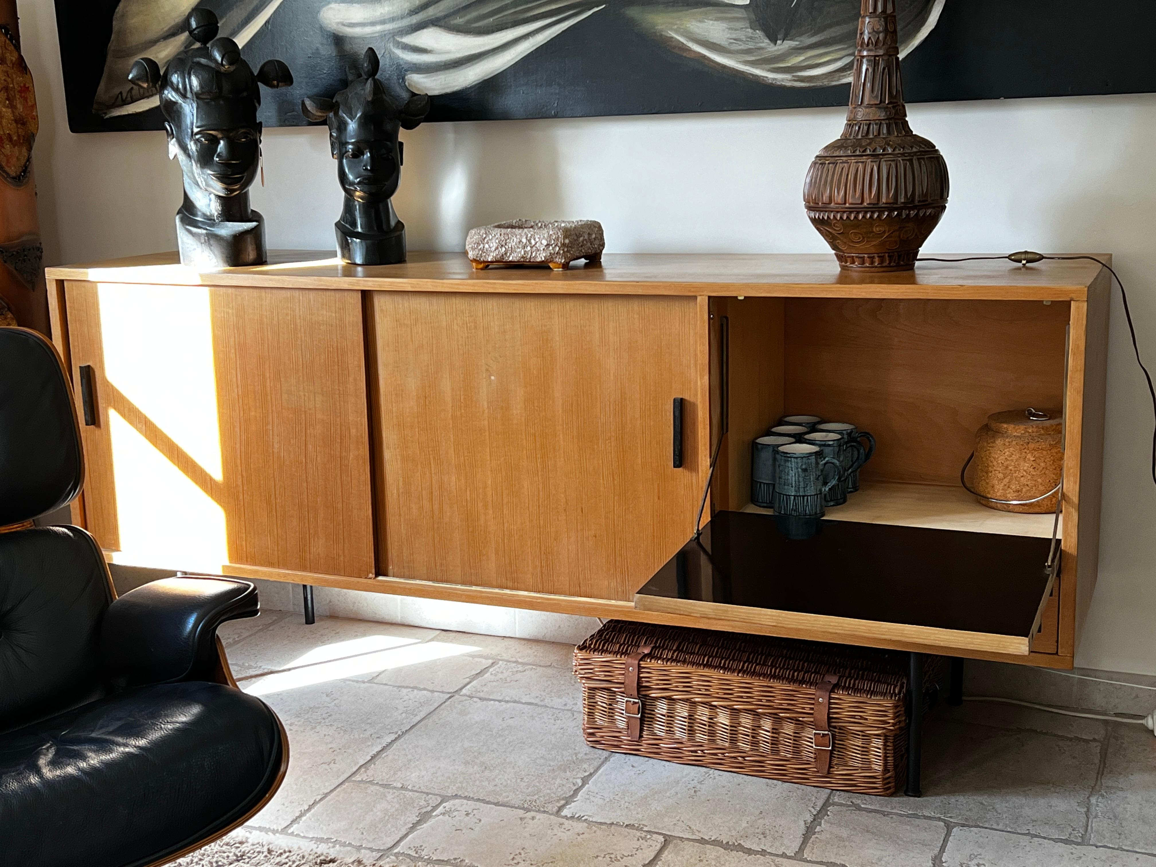 Sideboard by Gérard Guermonprez circa 1950, produced by Magnani. Structure in ash veneer opens with two sliding doors and a flap and 1 drawer on the right.