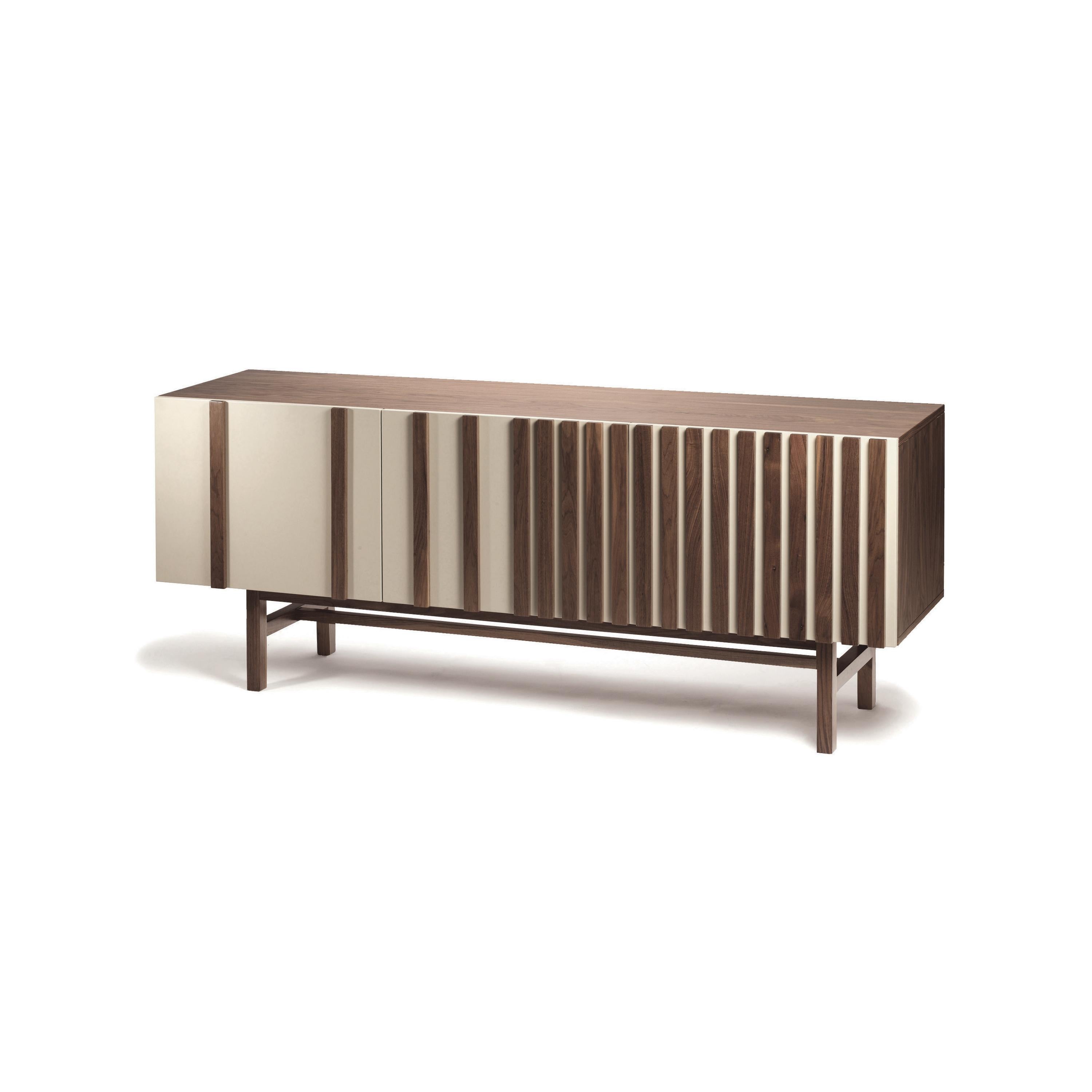 Go sideboard is a high quality product by Mambo Unlimited Ideas, crafted in lacquered mdf structure and doors and plywood veneer applications on doors. It features three dimensional designs on its doors, elegant vertical stripes of plywood