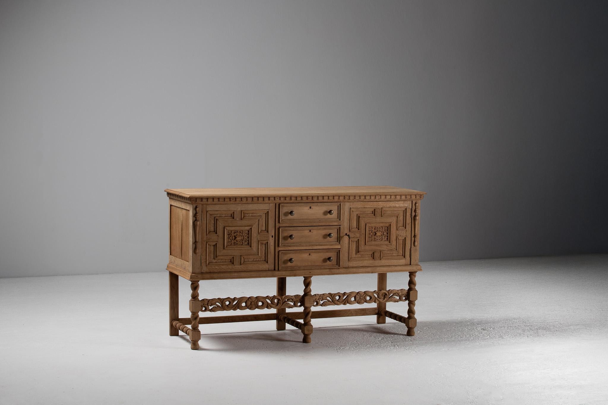 This sideboard unfolds as a wooden reliquary of Iberian heritage, its façade a dialogue of geometry and ornament. Deeply framed panels converge in architectural precision, drawing the eye inward to latticed medallions—each a miniature tapestry of