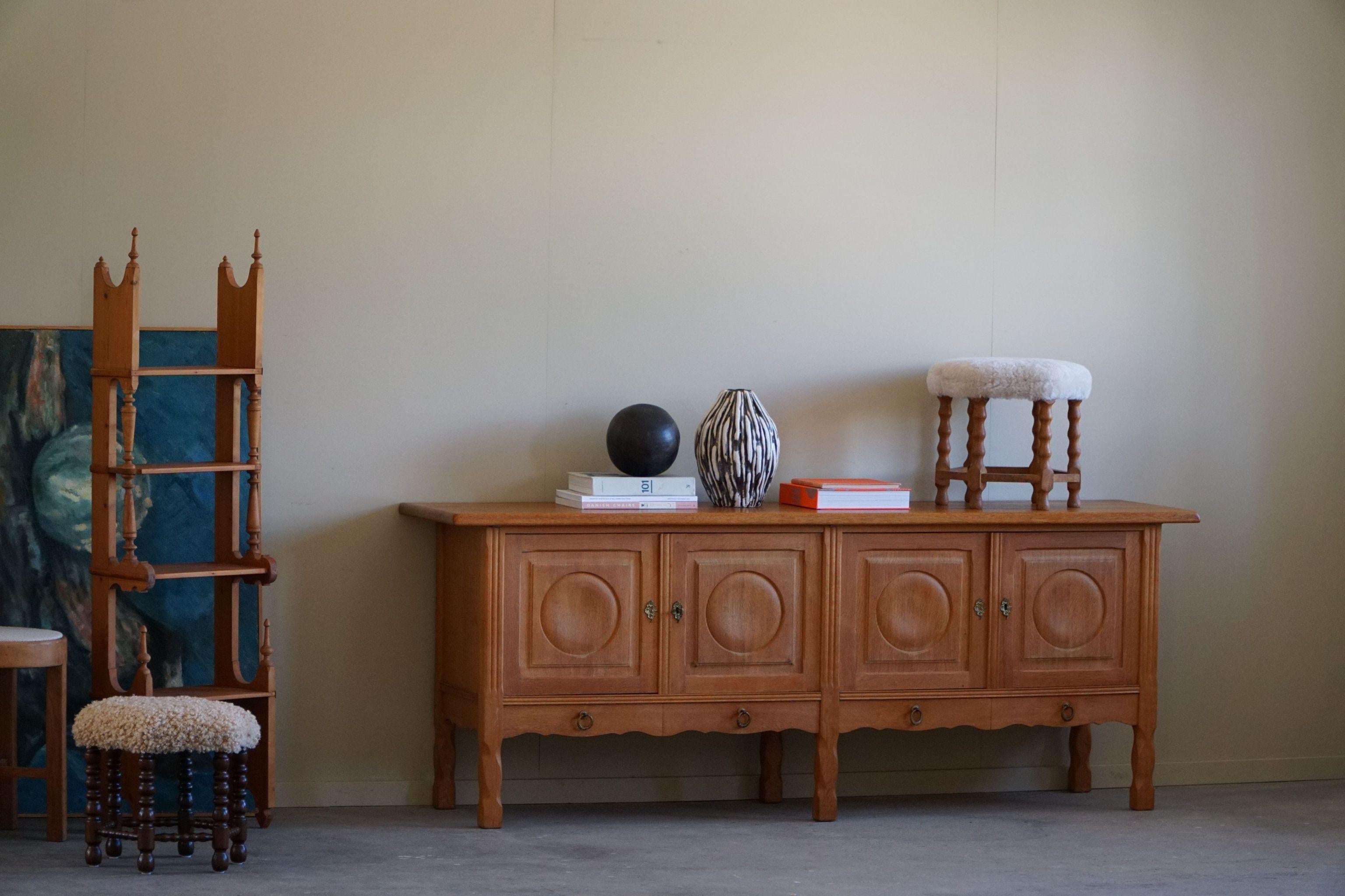 A fantastic low classic sideboard in solid oak. Made by a Danish Cabinetmaker, Anker Sørensen in the 1960s. This piece is in a good vintage condition, with few traces of wear.

This brutalist object will fit into many interior styles. A Modern,