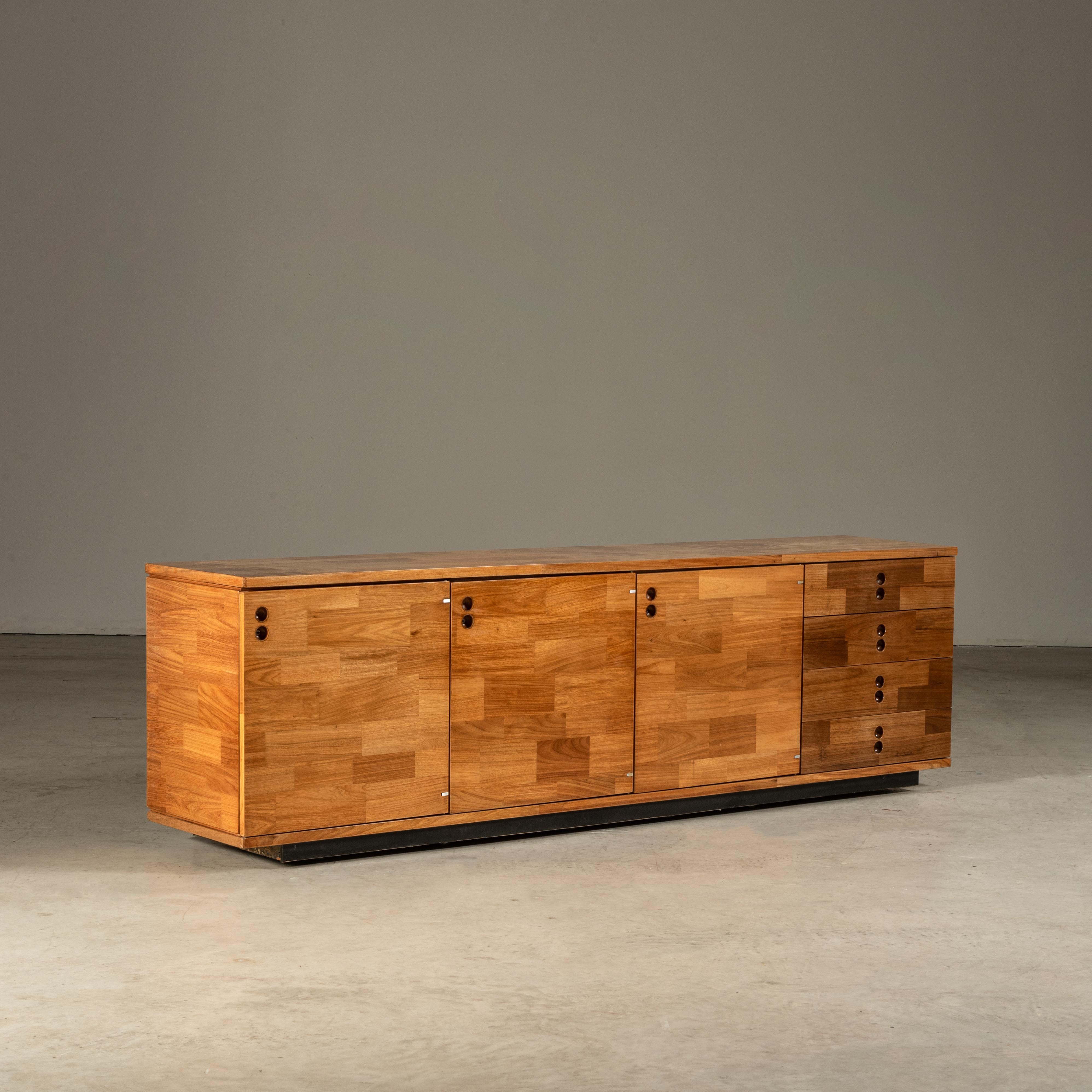 This exquisite sideboard, a creation of the renowned designer Jorge Zalszupin, epitomizes the elegance of Brazilian mid-century modern design. It is masterfully crafted from a selection of tropical hardwood, a material choice that not only honors