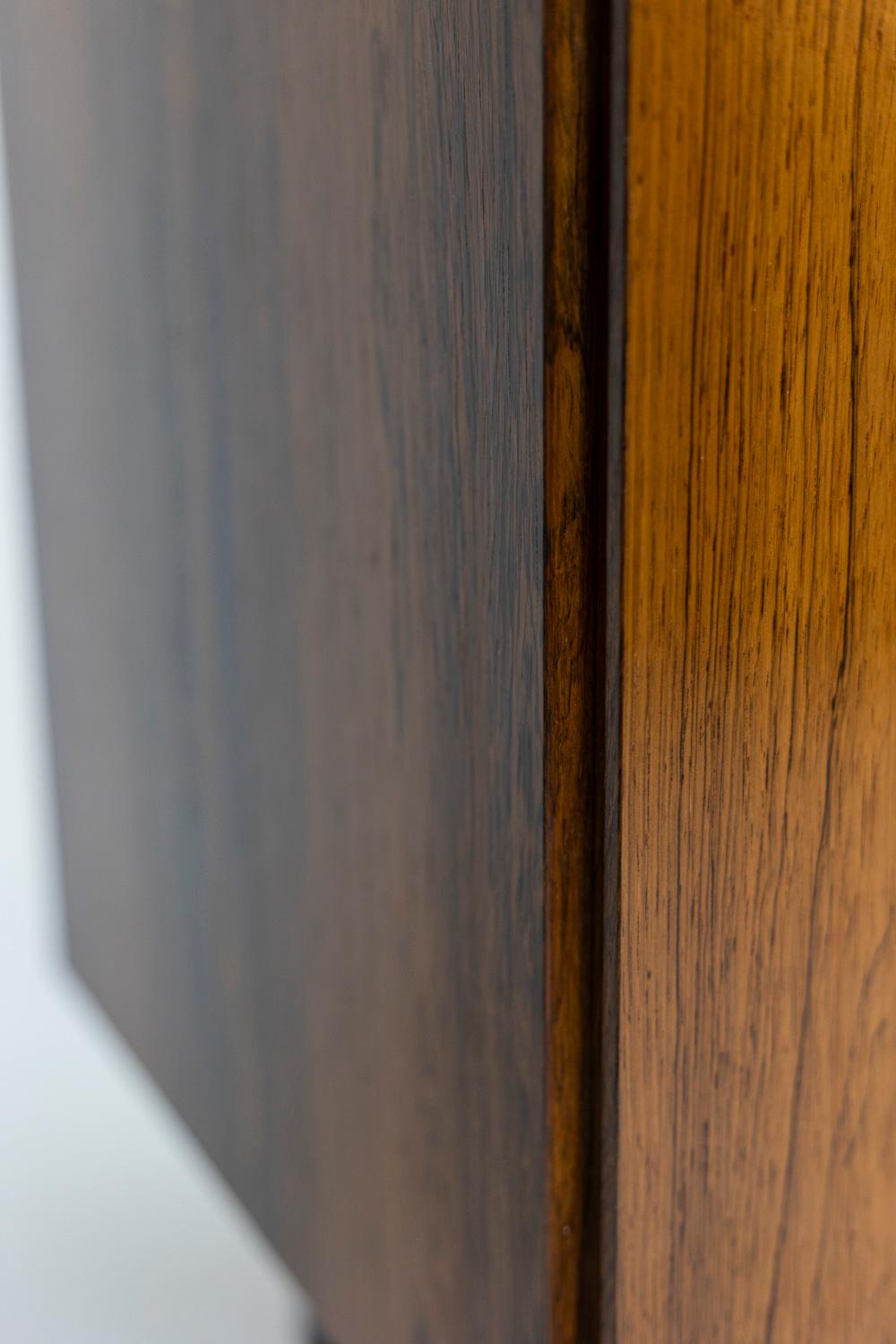 Sideboard in rosewood opening with a door and standing on four black metal legs.

Danish work realized in the 1970.
Dimensions : H 73 x W 65 x D 45 cm.