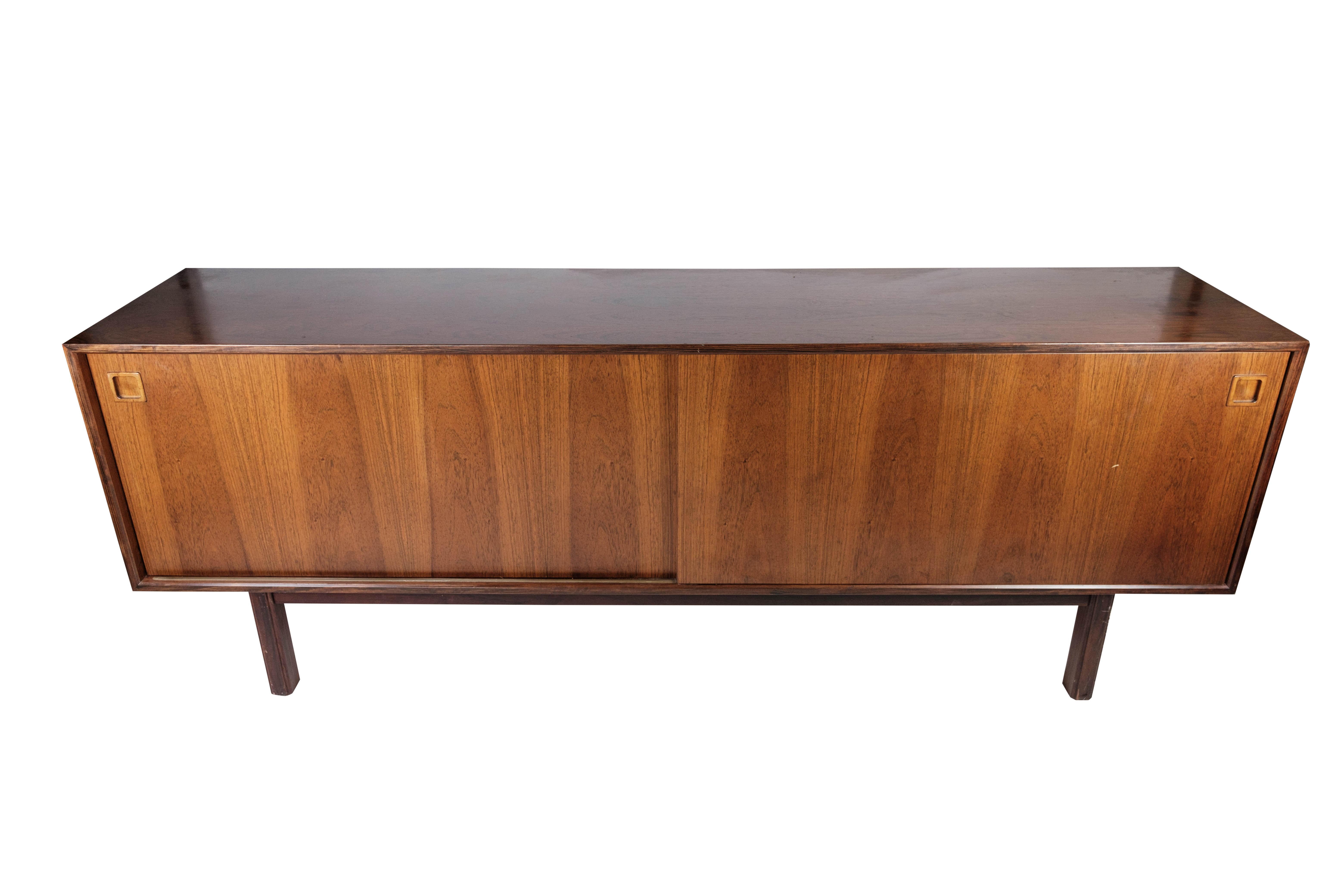 Sideboard in rosewood with sliding doors designed by Omann Junior from the 1960s. The sideboard is in great vintage condition.
    