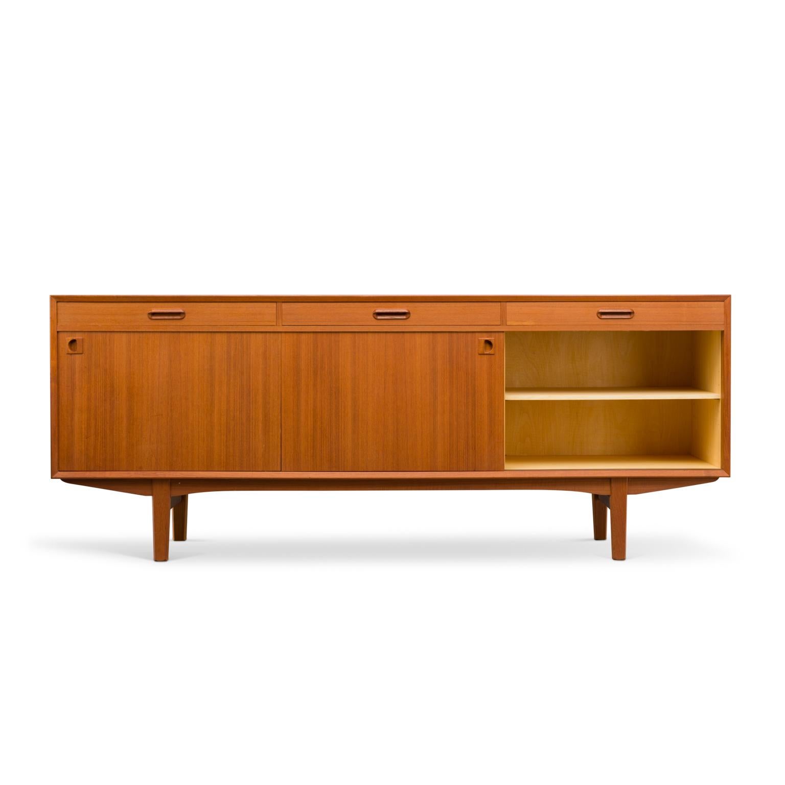 This Danish modern teak sideboard is a top quality chest from Skovby Møbelfabrik. Drawers close with precision fit and have dovetail joints. Used materials are of high quality and the base indicates high end. The base of this credenza is off solid