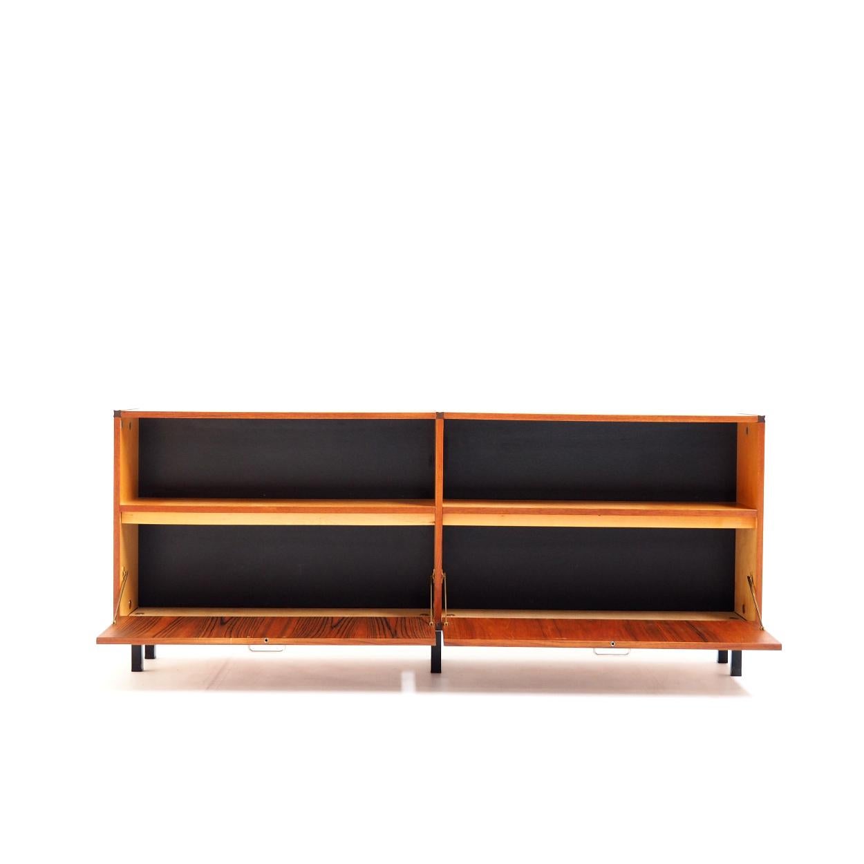 Sideboard in teak designed by Cees Braakman for Pastoe. It comes from the 'Made to Measure' series that was produced in the Netherlands from the early 1950s to the mid-1960s.

The sideboard has a special composition with two fall fronts as doors,