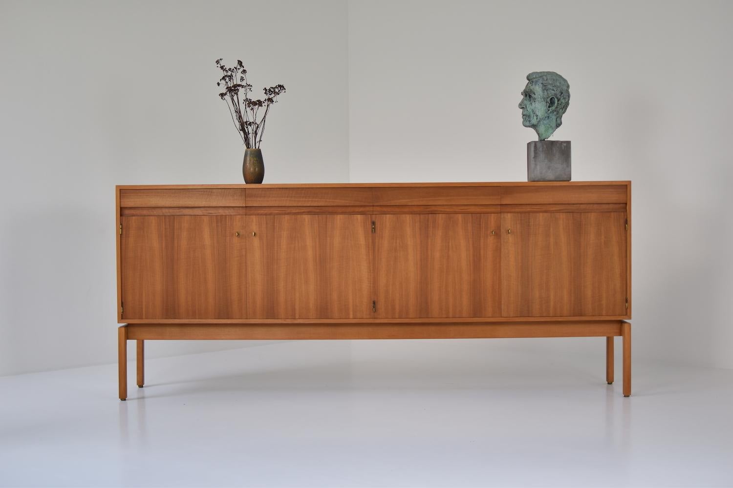 Sideboard in walnut by Jos de Mey for Van den Berghe-Pauvers, Belgium, 1960s. This credenza features four large doors and four drawers with hand casted brass handles. Part of the beautiful abstract series! Fully restored. Labeled.