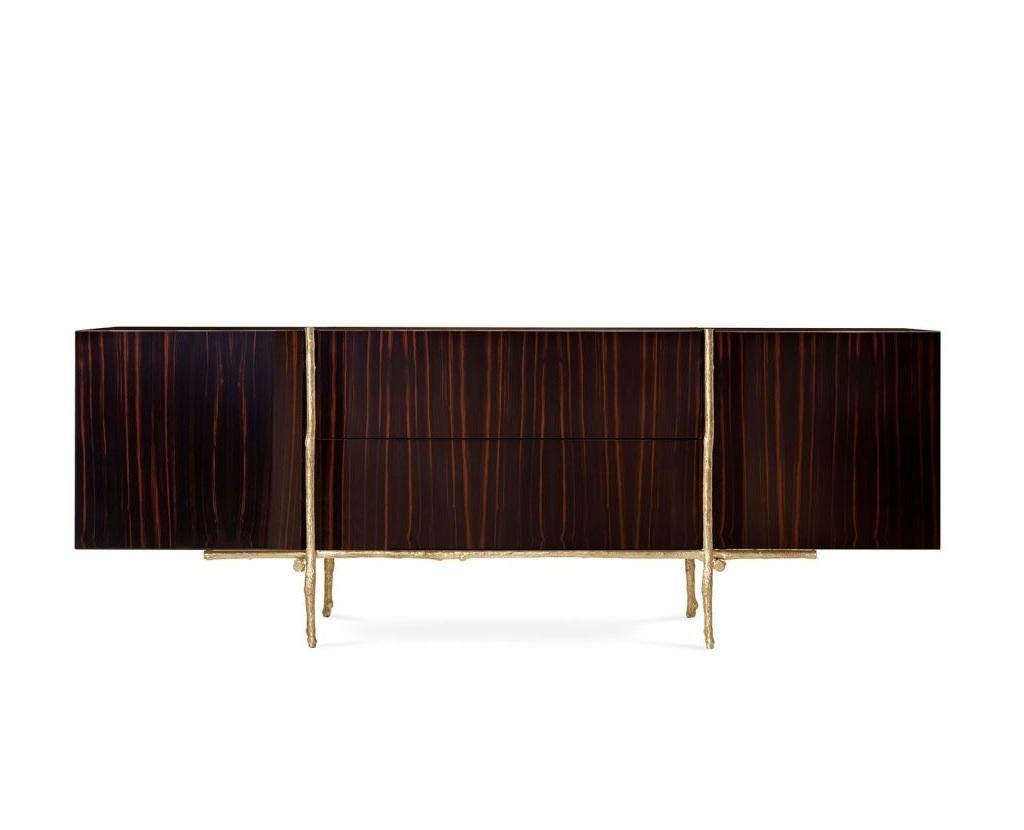 This sideboard pays homage to lavish forest canopies, hosting trees that bask in the sun whilst sheltering the growing saplings beneath. The oak branches of the legs have been cast from a brass mold, and are surmounted by a sideboard comprising a