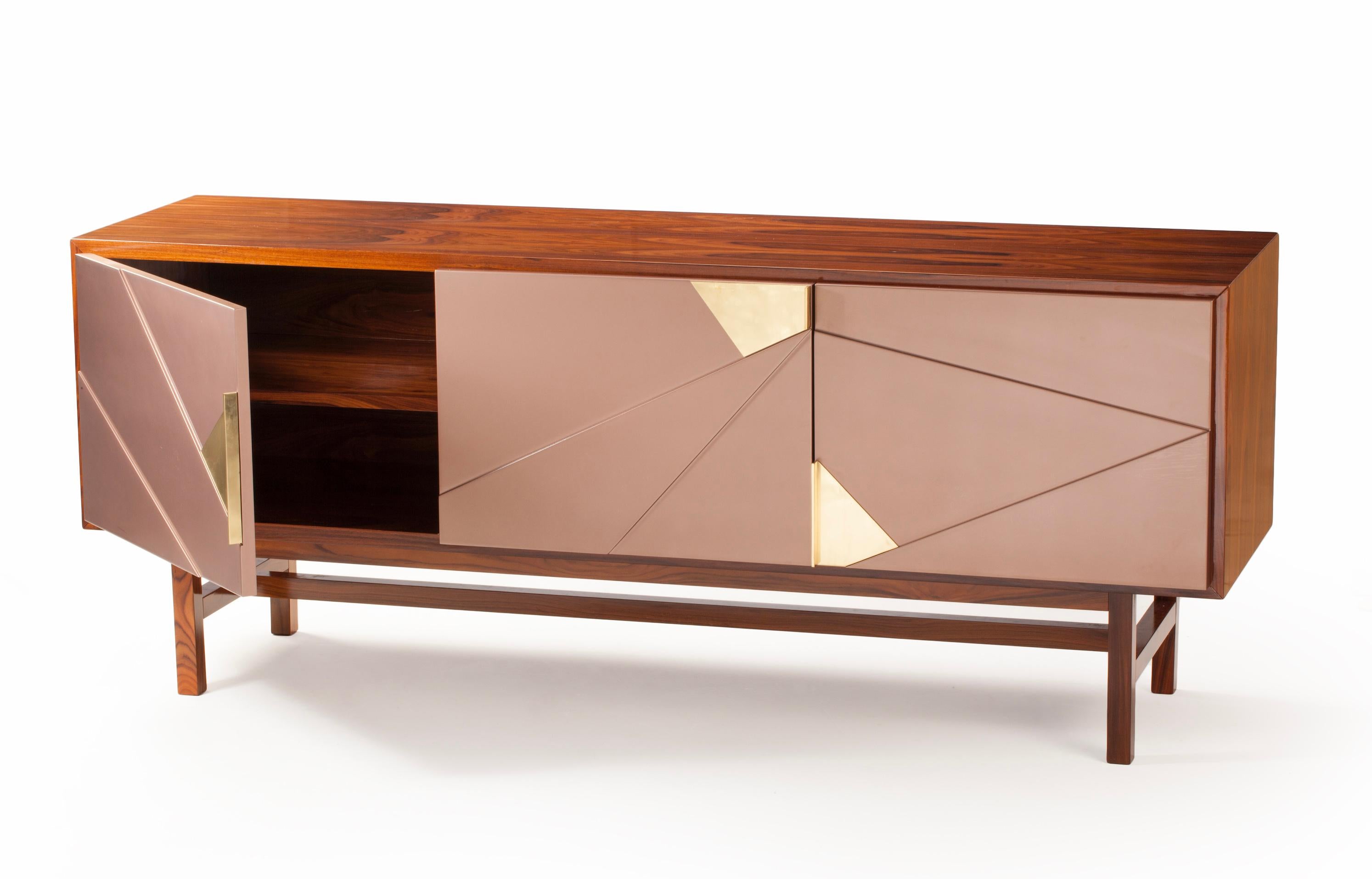 Jazz sideboard is a high quality product by Mambo Unlimited Ideas, crafted in polished or matte iron wood venner structure and feet, brass applications and lacquered doors. It features three dimensional designs on its doors, elegant oxidized brass