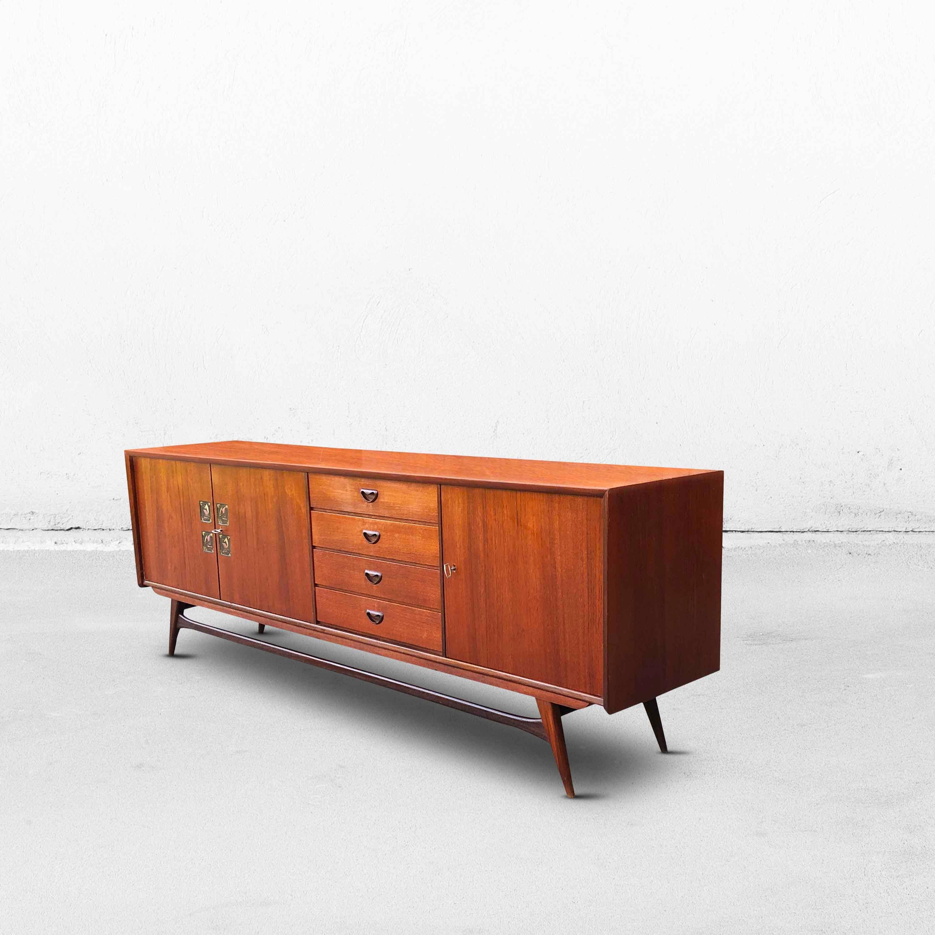 A beautiful teak sideboard by Louis Van Teeffelen for Wébé from the 1960s. The inlaid tiles were designed by Jaap Ravelli. This sideboard has a large storage compartment with a shelf, 4 drawers, and a smaller storage compartment with a shelf. The 2
