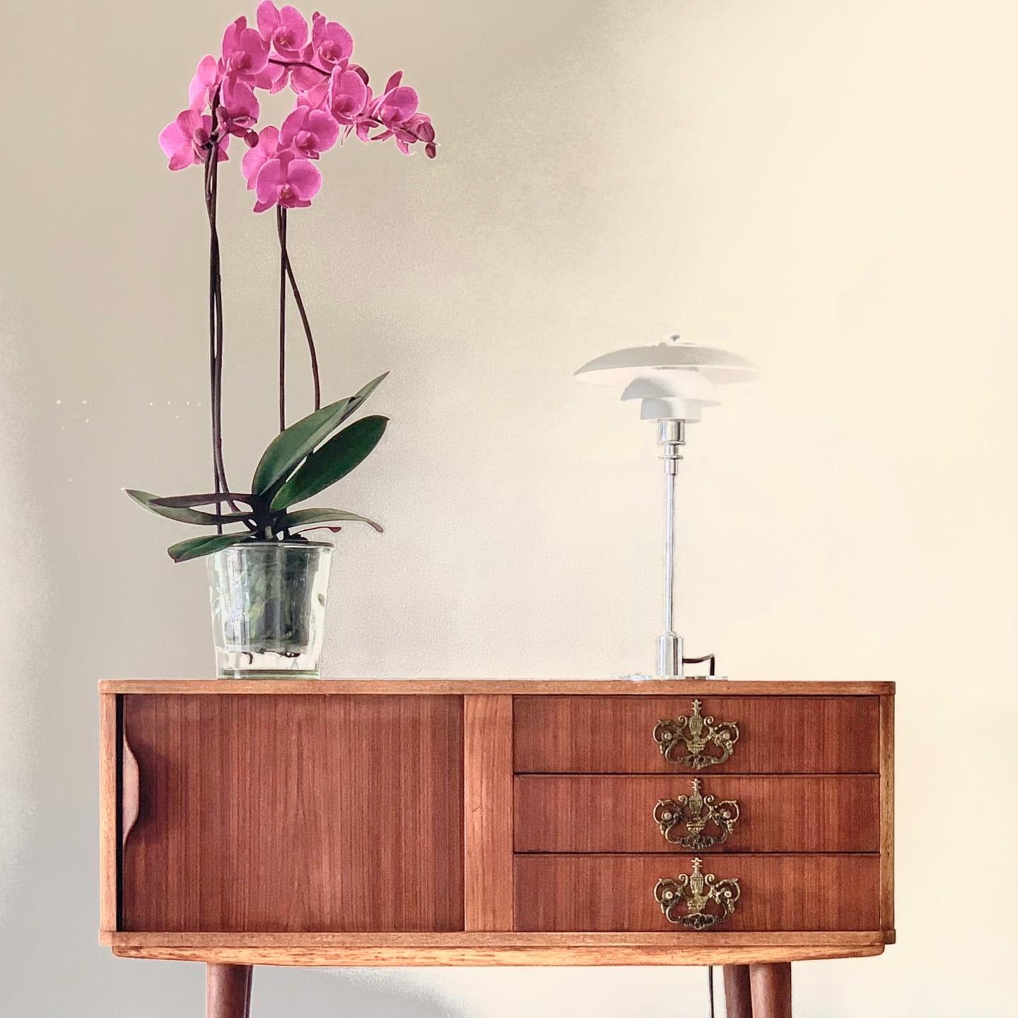 Small teak midcentury sideboard

- A versatile piece of furniture
- Top plate with round edges
- Tambour door with beautiful handle
- Tall tapered legs and beautiful wood grains.
- Danish architect, 1950s.

 
