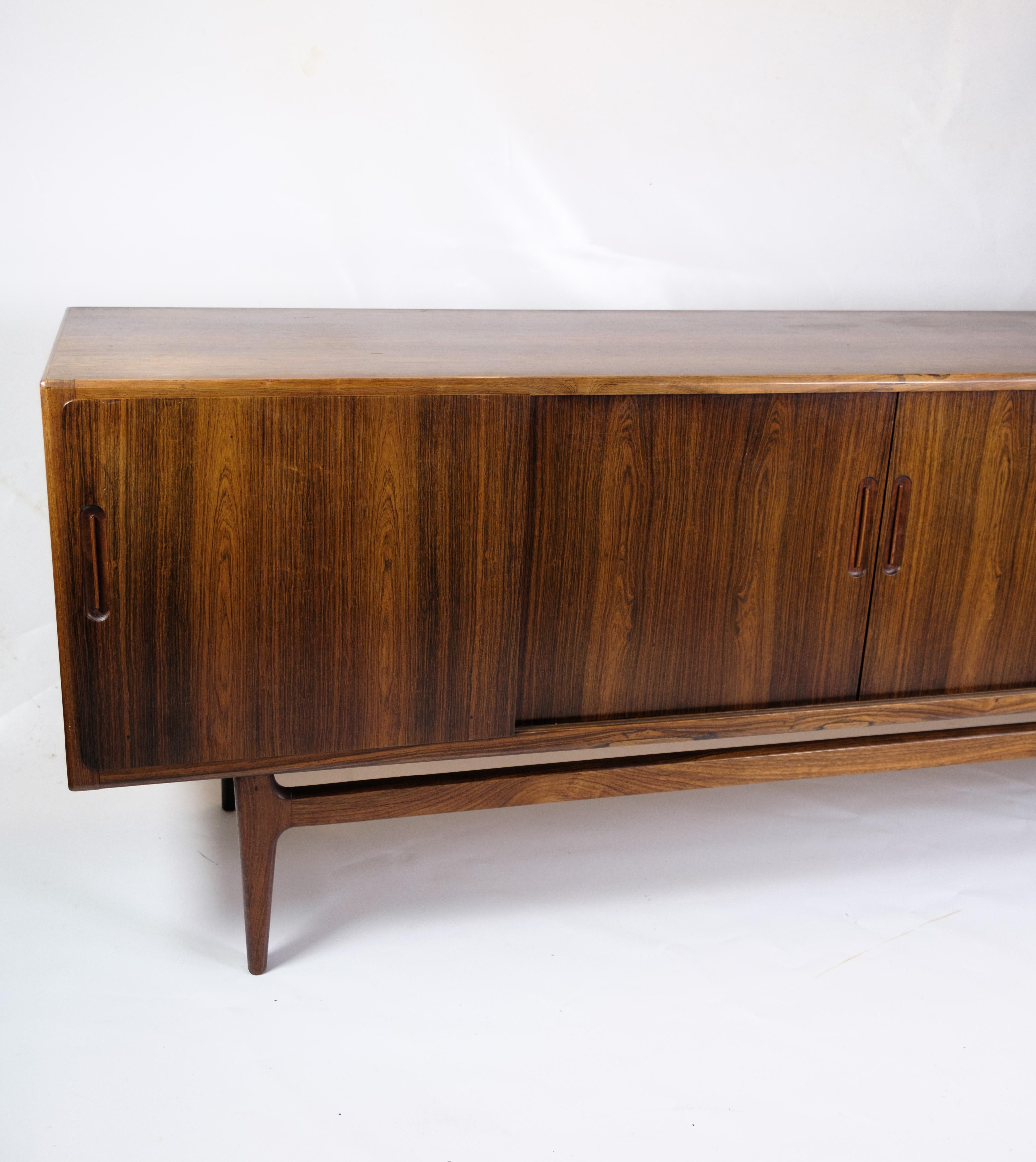 The sideboard is an impressive example of Danish furniture art from the 1960s, where rosewood was used to create beautiful and functional furniture. Rosewood and the solid rosewood legs give the sideboard an elegant and timeless appearance that fits