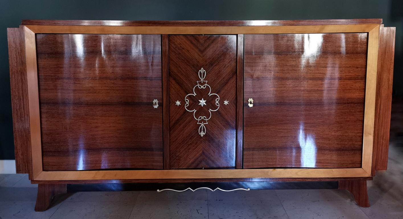 Elegant sideboard handcrafted in France between 1948 and 1950; various types of precious exotic woods of exceptional quality have been used, creating a truly pleasant and refined chromatic effect; the shape is particularly clean and linear; the