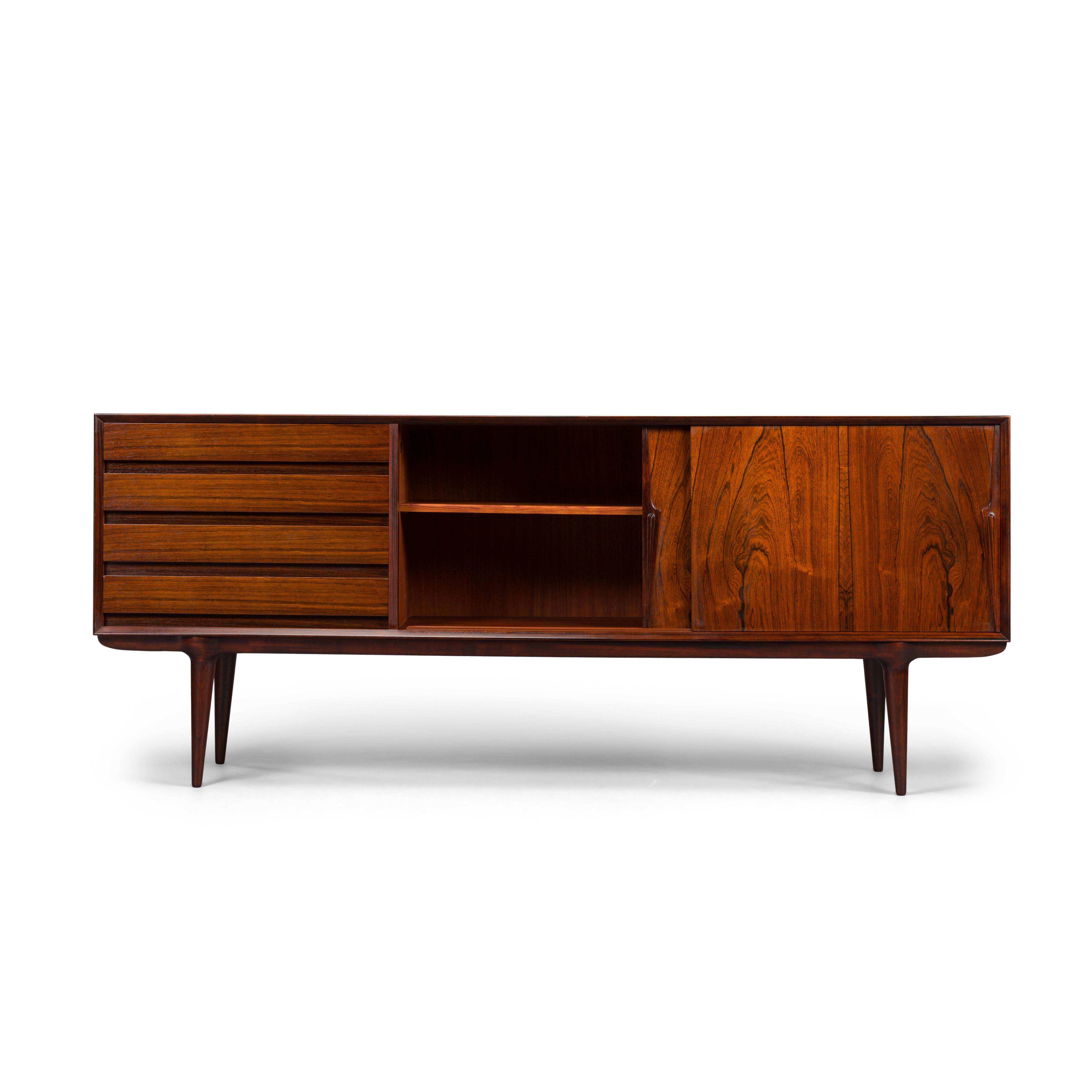 A Classic among credenza's, this model #18 credenza designed by Gunni Omann for Omann Jun Møbelfabrik. Recognizable design features and perfectly proportioned, with a low profile design, this piece will work well with any modern decor. Superb level