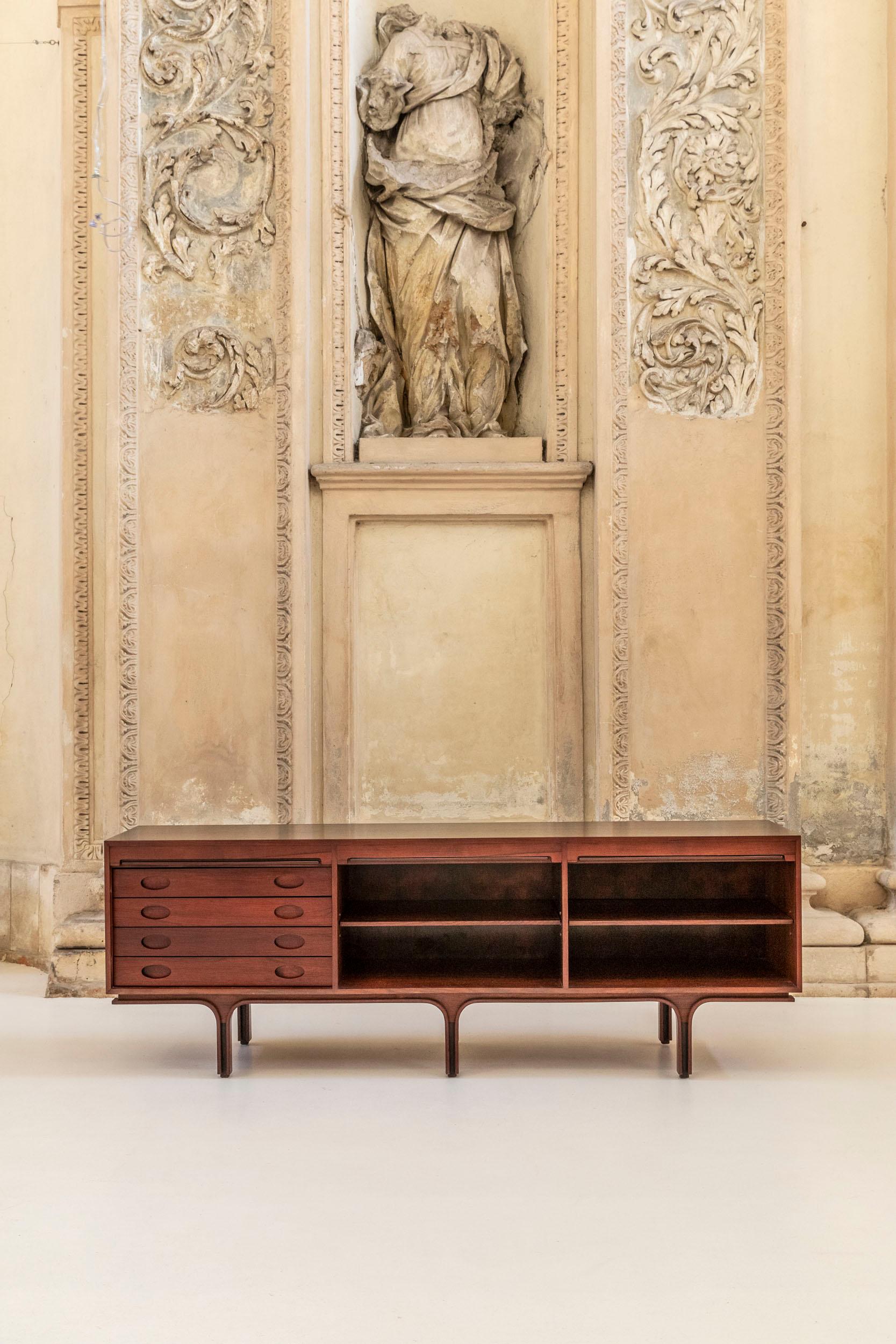 Iconic sideboard, model 503, design by Gianfranco Frattini, manufactured by Bernini, 1960 Italy circa. 
Three vertical tambour doors, four drawers on the left side and adjustable shelves in the other two sections.

Bibliography 