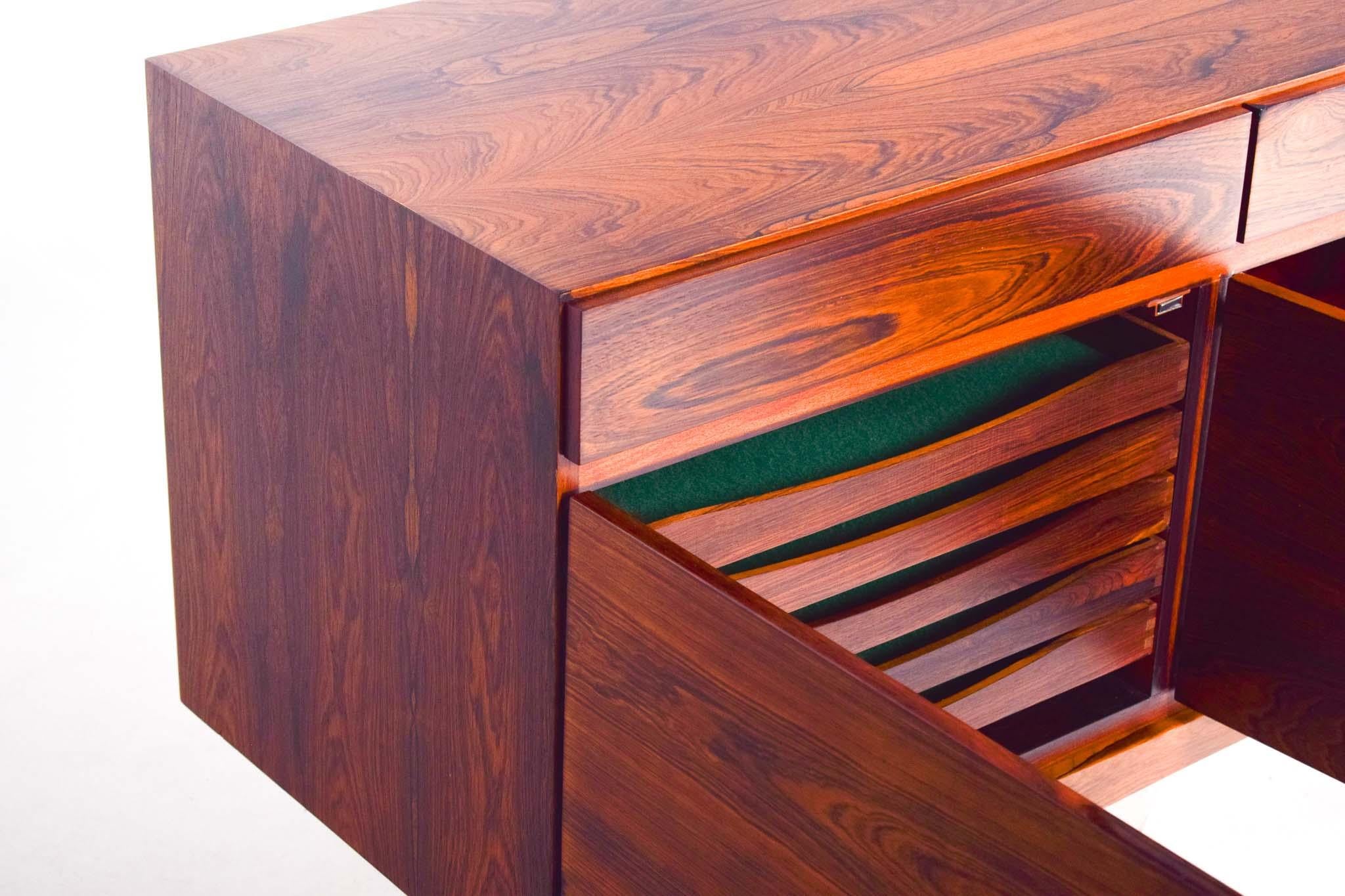 Designed by the acclaimed Ib Kofod-Larsen and manufactured by Faarup Mobelfabrik in the 1960s, this sideboard is a masterpiece of Danish mid-century modern design. The clean lines and minimalist aesthetic are hallmarks of Kofod-Larsen's work, making