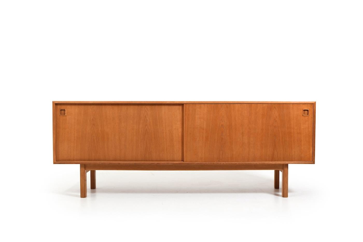 Omann Jun. sideboard, model no.21 in oak. In front with sliding doors and inside with shelfes and drawers. Denmark, 1960s. In very good vintage condition, with minor signes of age. Size: W. 210 cm / D. 47 cm  / H. 79 cm