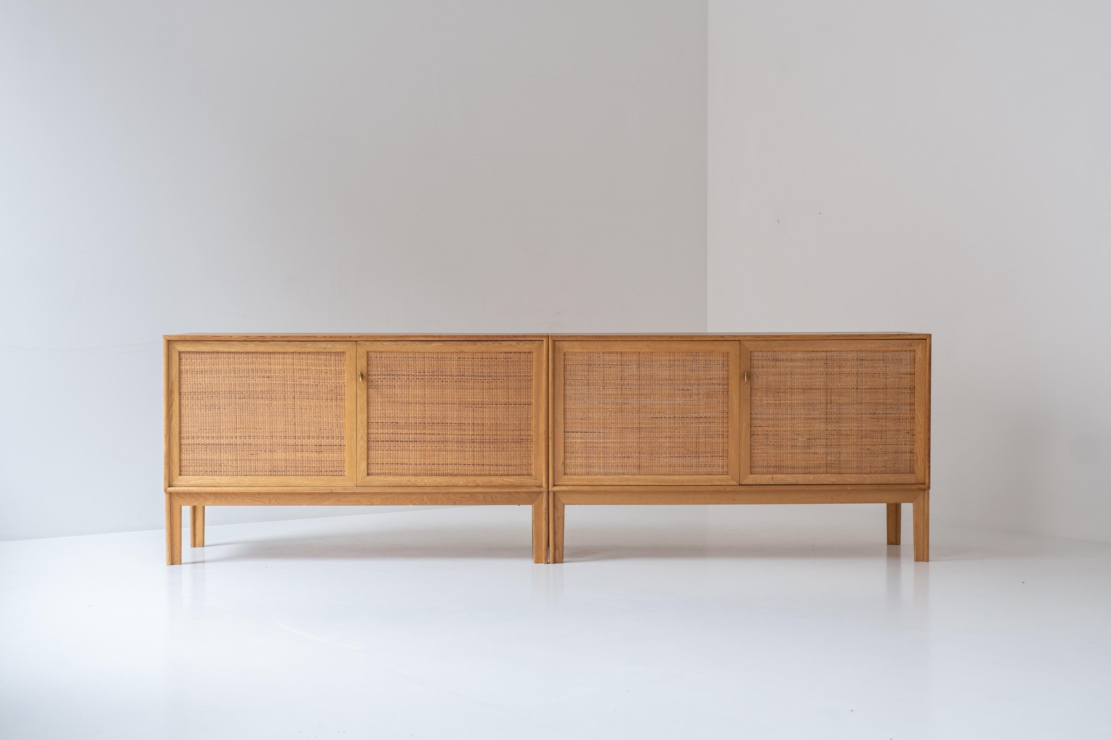 Sideboard, model Norrland, by Alf Svensson for Bjästa Möbelfabrik, Sweden 1960s. This sideboard consists of 2 smaller cabinets made out of oak and rattan. One sideboard contains several adjustable shelves, and the other features a combination of