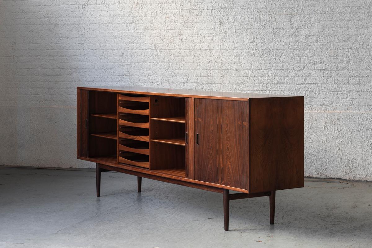 Freestanding sideboard, OS36, designed by Arne Vodder and produced for Sibast furniture, Denmark 1960’s. Solid rosewood and rosewood veneer cabinet. The left cabinet features two tambour doors, sliding into the side panels. The high-quality