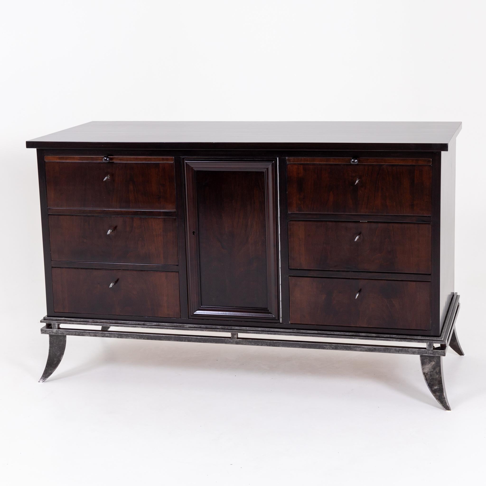 Sideboard on elegant iron frame with flared saber legs, six drawers and one door. Above the drawers can be pulled out more countertops.