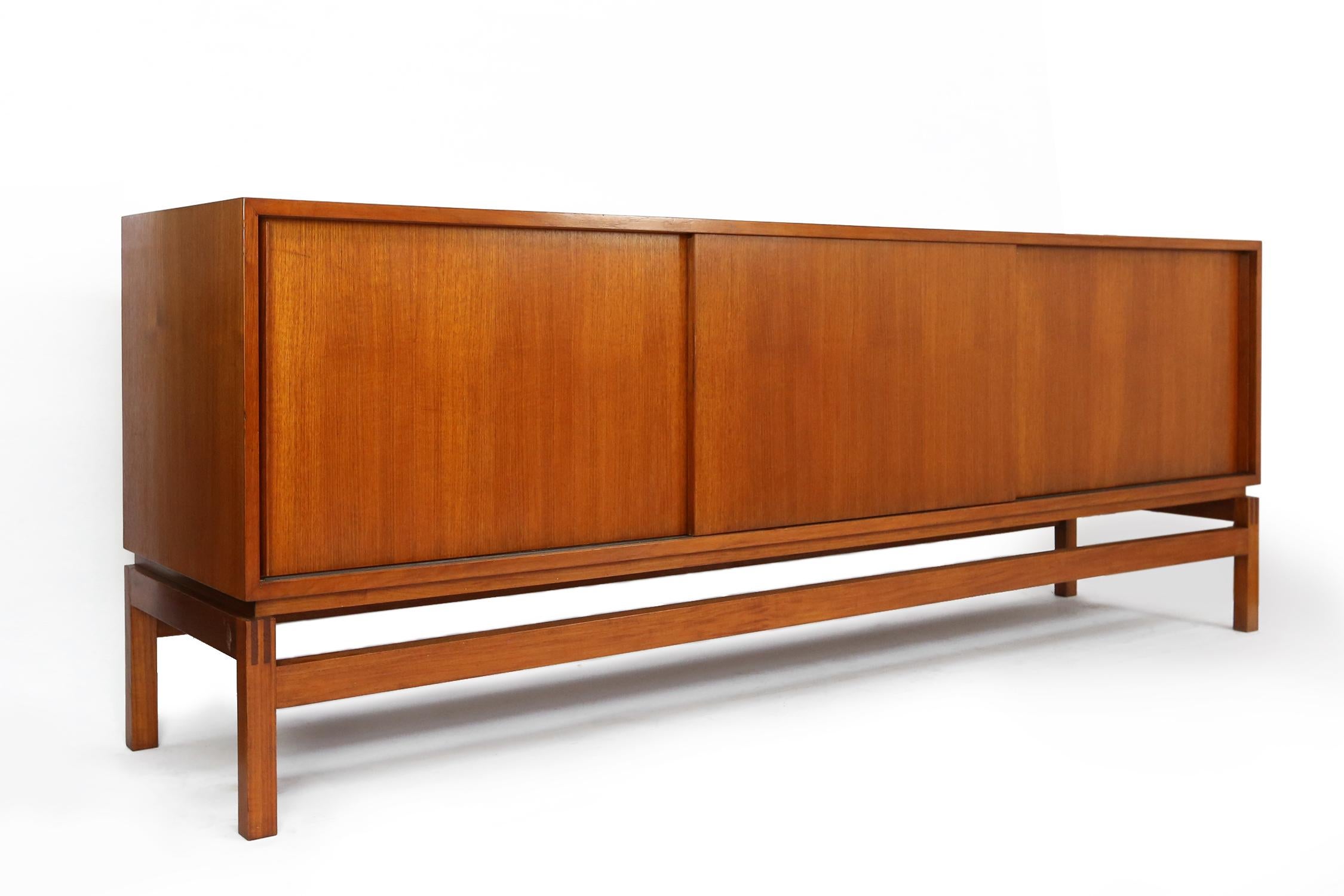 Monumental sideboard by Emiel Veranneman, Belgium designer in the 1970s. This exclusive cabinet was made in solid teak wood and is very rare to find. Floating in an elegant shaped wooden frame gives a light feeling to this large storage piece. Both
