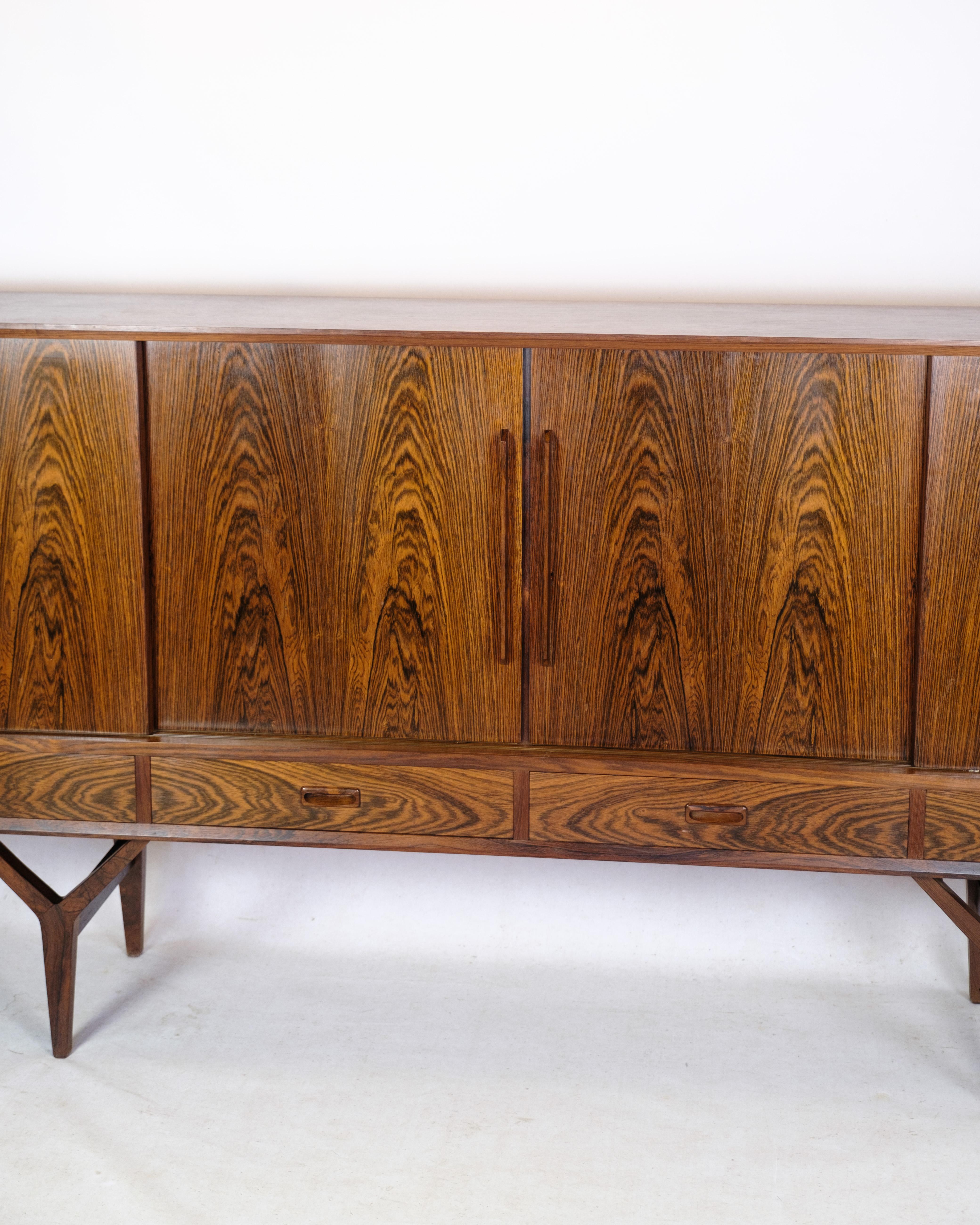 Sideboard in rosewood of Danish design with 4 sliding doors and 4 drawers from around the 1960s.
Measurements in cm: H:109 W:220 D:43.5