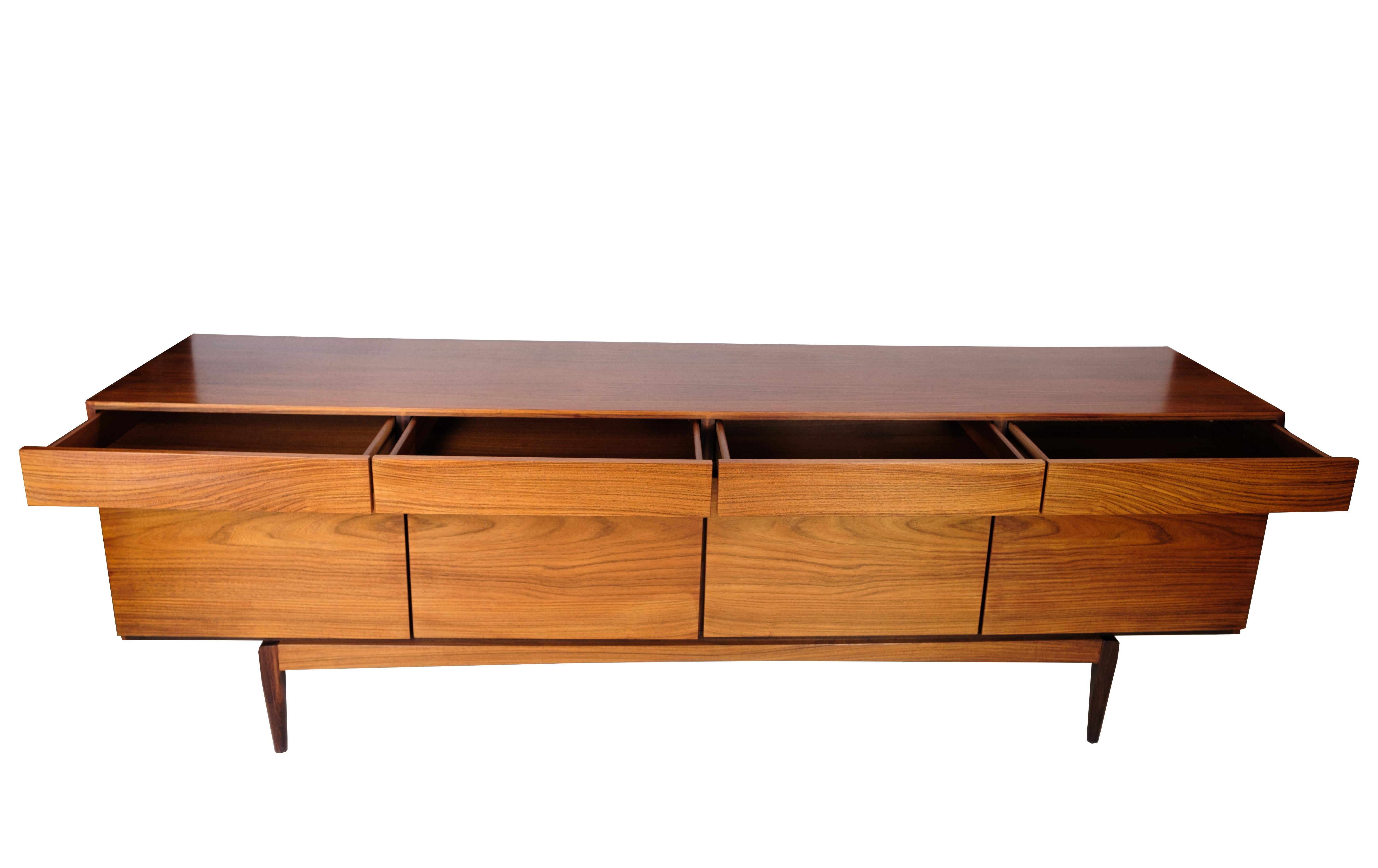 Sideboard in rosewood designed by Ib Kofod-Larsen, model FA66 manufactured by Faarup Møbelfabrik in the 1960s. A low freestanding sideboard of the highest quality. It is veneered with rosewood with a very beautiful structure. In the front, it has