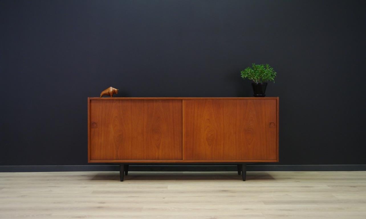 Stylish sideboard, Danish minimalism from the 1960s-1970s A Classic form with a capacious interior with shelves and drawers with sliding doors. Sideboard veneered with teak. Preserved in good condition (small dings and scratches, filled veneer