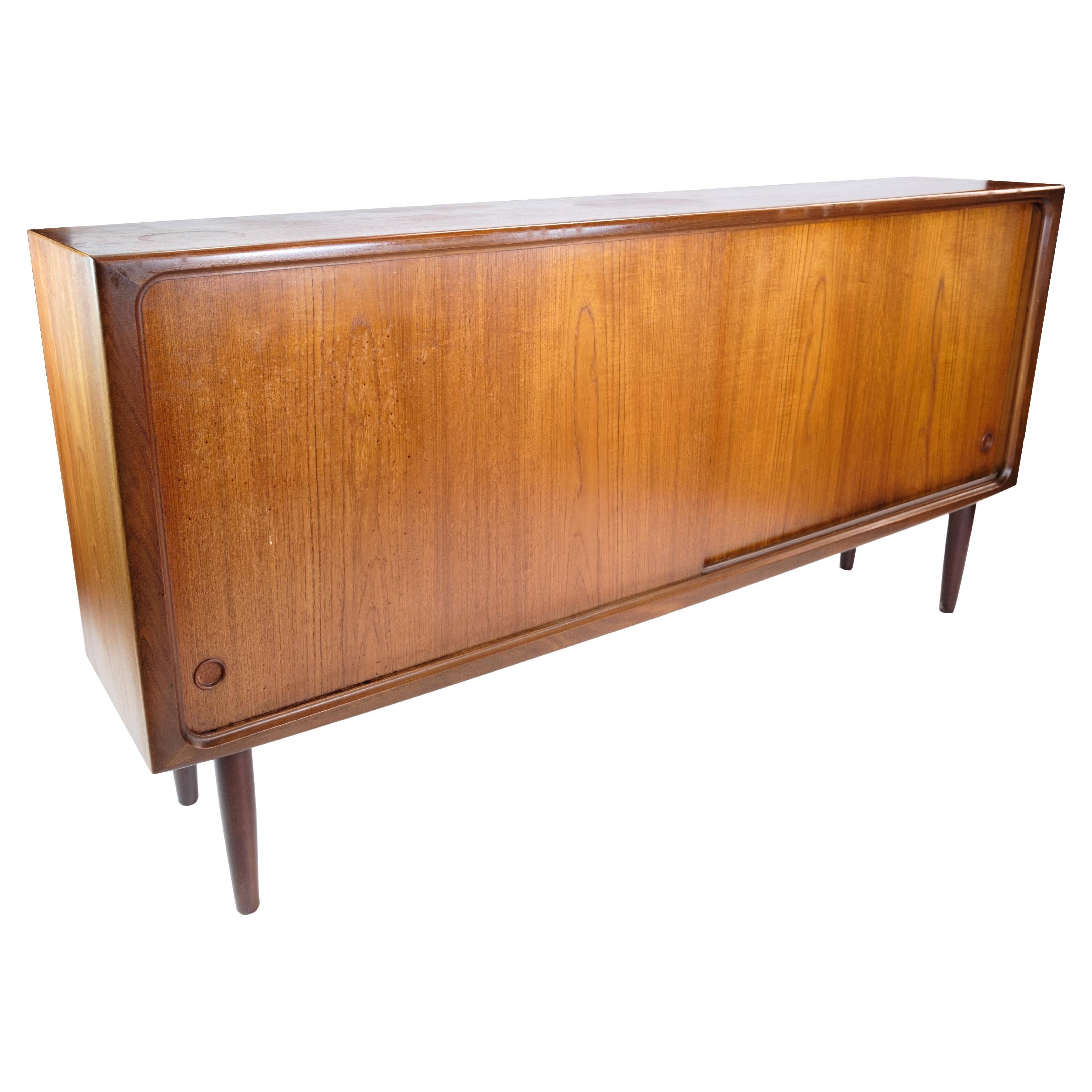 Small sideboard in teak wood of Danish design from around the 1960s. The sideboard has 2 sliding doors with internal glass and shelves.

This product will be inspected thoroughly at our professional workshop by our educated employees, who assure