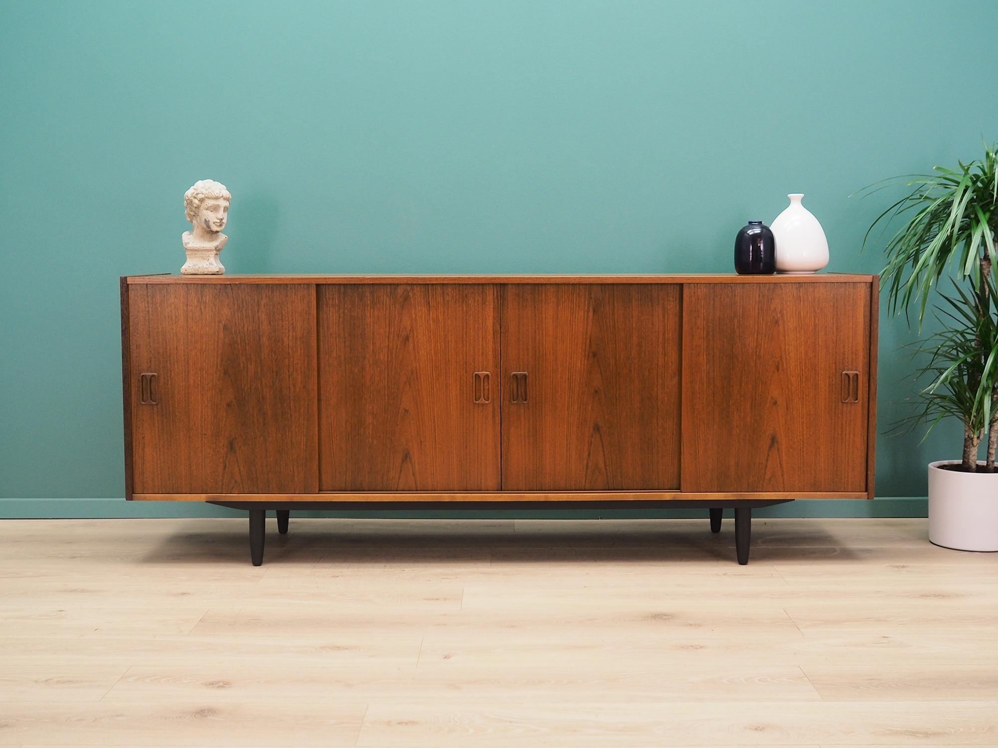 Sideboard was made in the 1960s and was produced by the famous Danish manufactory Westergaard.

The structure is covered with teak veneer. The legs are made of solid wood stained black. Surface after refreshing. Inside the space has been filled