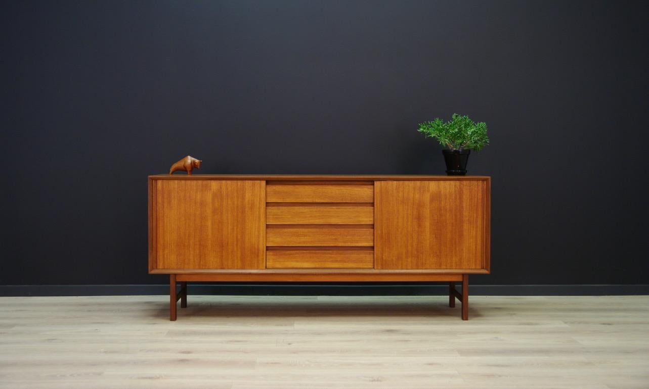 Phenomenal sideboard from the 1960s-1970s, Minimalist form - Danish design. Surface finished with teak veneer. Spacious interior behind sliding doors and four capacious drawers. Preserved in good condition (minor scratches and dings) - directly for