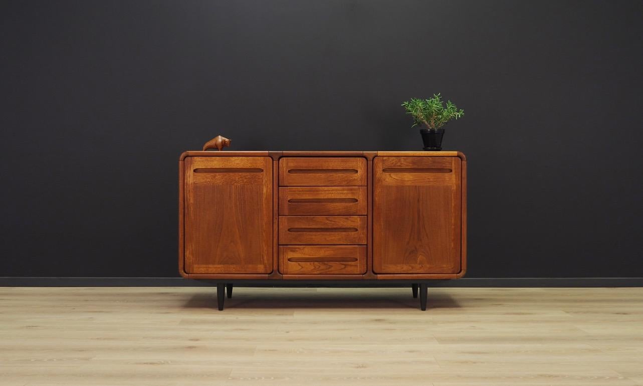 Fantastic sideboard from the 1960s-1970s, Danish design, covered with teak veneer. Plenty of space with a shelf behind sliding doors, and in the central section four functional drawers. Preserved in good condition (small bruises and scratches) -