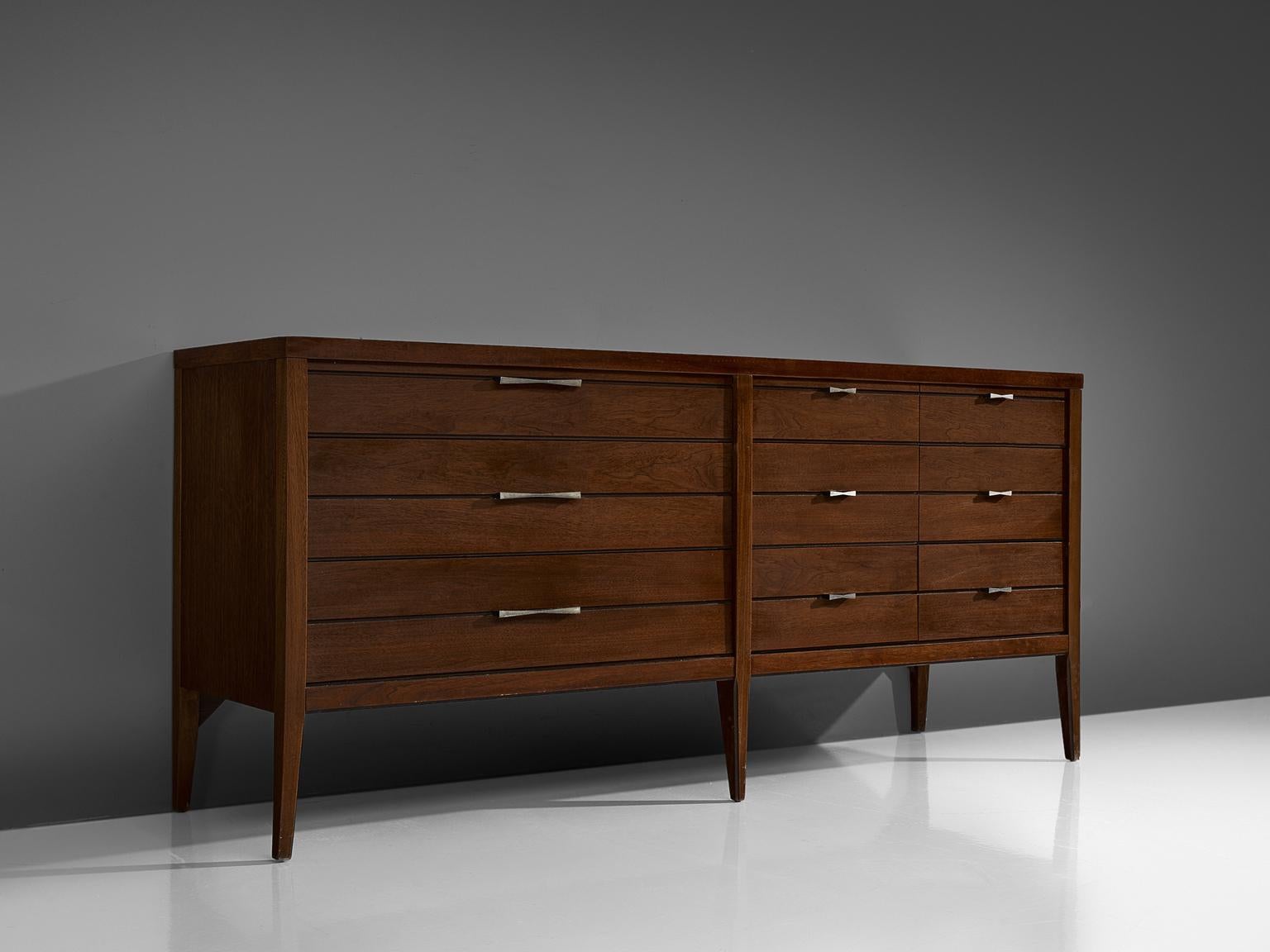 Sideboard, walnut, rosewood and metal, United States, 1950s.

This credenza features strong traits of the functional and modest furniture line of Paul McCobb. The piece features nine butterfly handles and beautiful matching butterfly joints on the