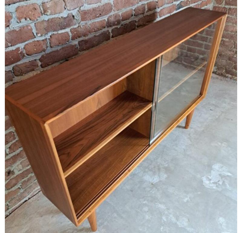 Sideboard with Glass Sliding Doors, Denmark, 1960

Additional information:
Country of Manufacture – Denmark
Design Period – 1960
Production Period – 1960
Style – Midcentury / Danish design
Material – Teak wood, glass
Color – Brown
Dimensions – 87 x